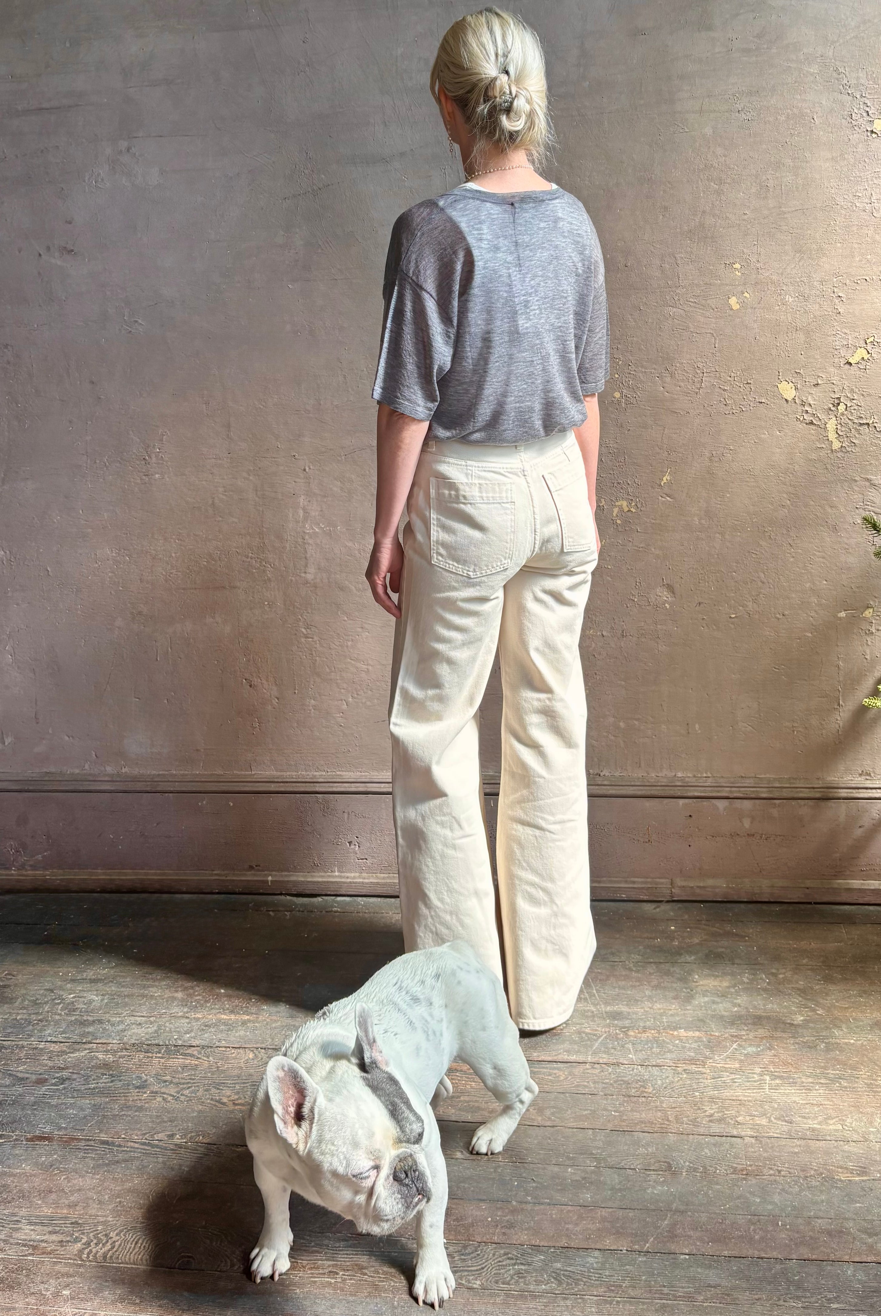 Mature woman wearing premium polished layer SPRWMN grey wool tee shirt with a v-neck and short sleeves
