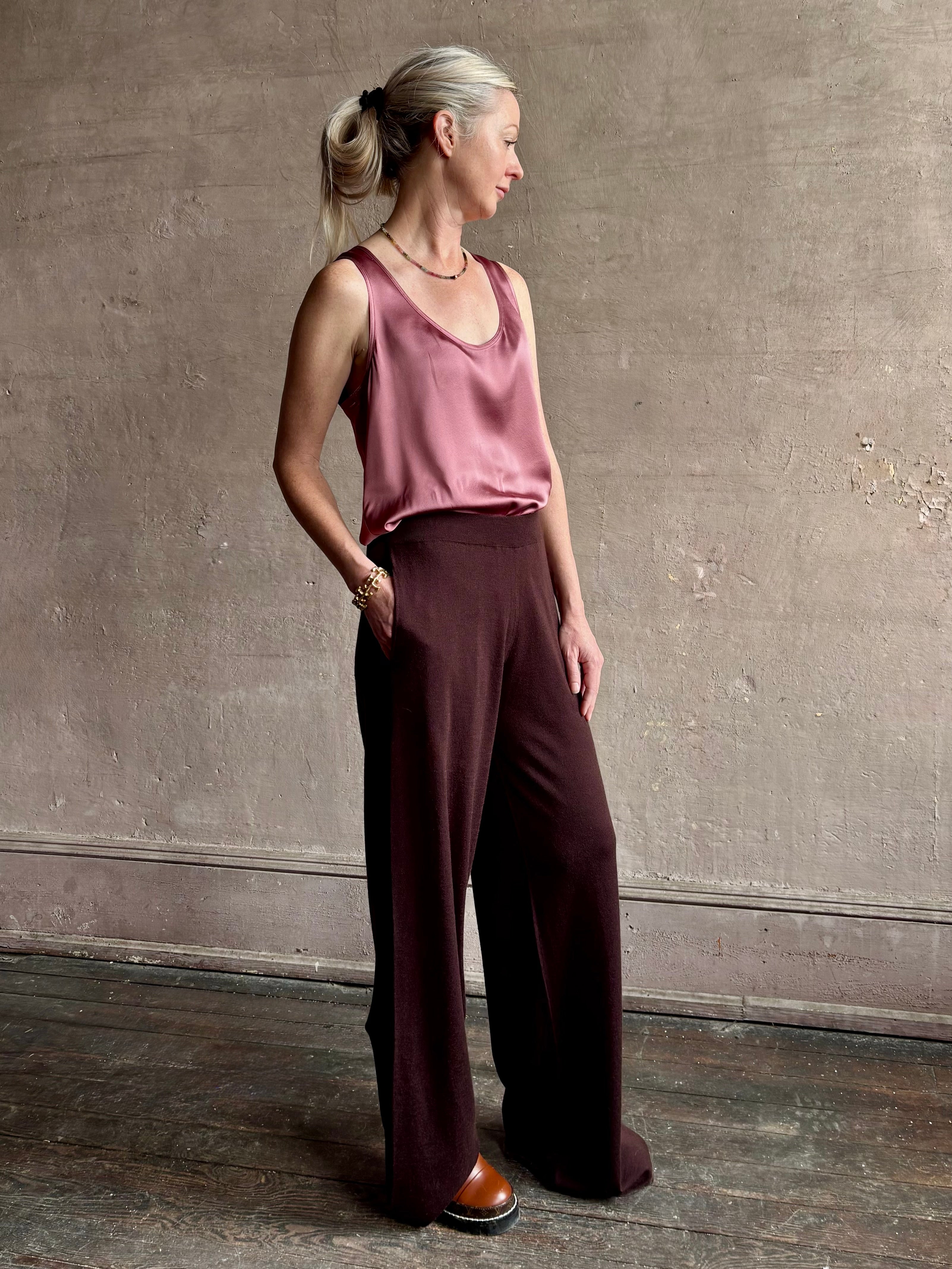 Image of woman wearing premium knit cashmere chocolate brown pant by SPRWMN with elastic waistband and mid-rise and flowy wide leg