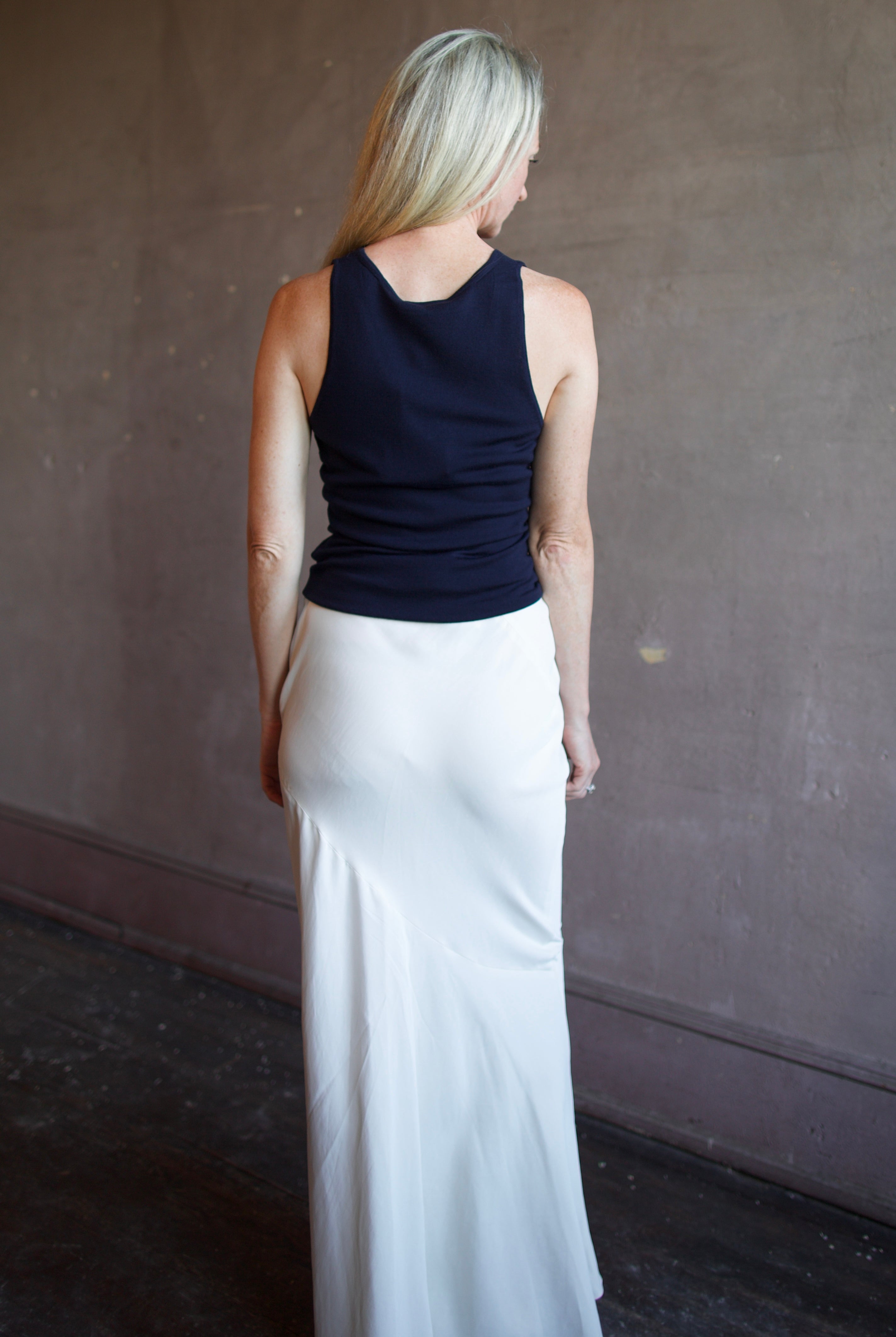 Model wearing luxury brand Sablyn Addyson v-neck layering tank in super fine merino wool for exceptional lightweight comfort