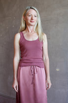 Model wearing luxury brand Sablyn layering coco scoop neck tank top in rich mauve colorway with premium ribbed texture fabric