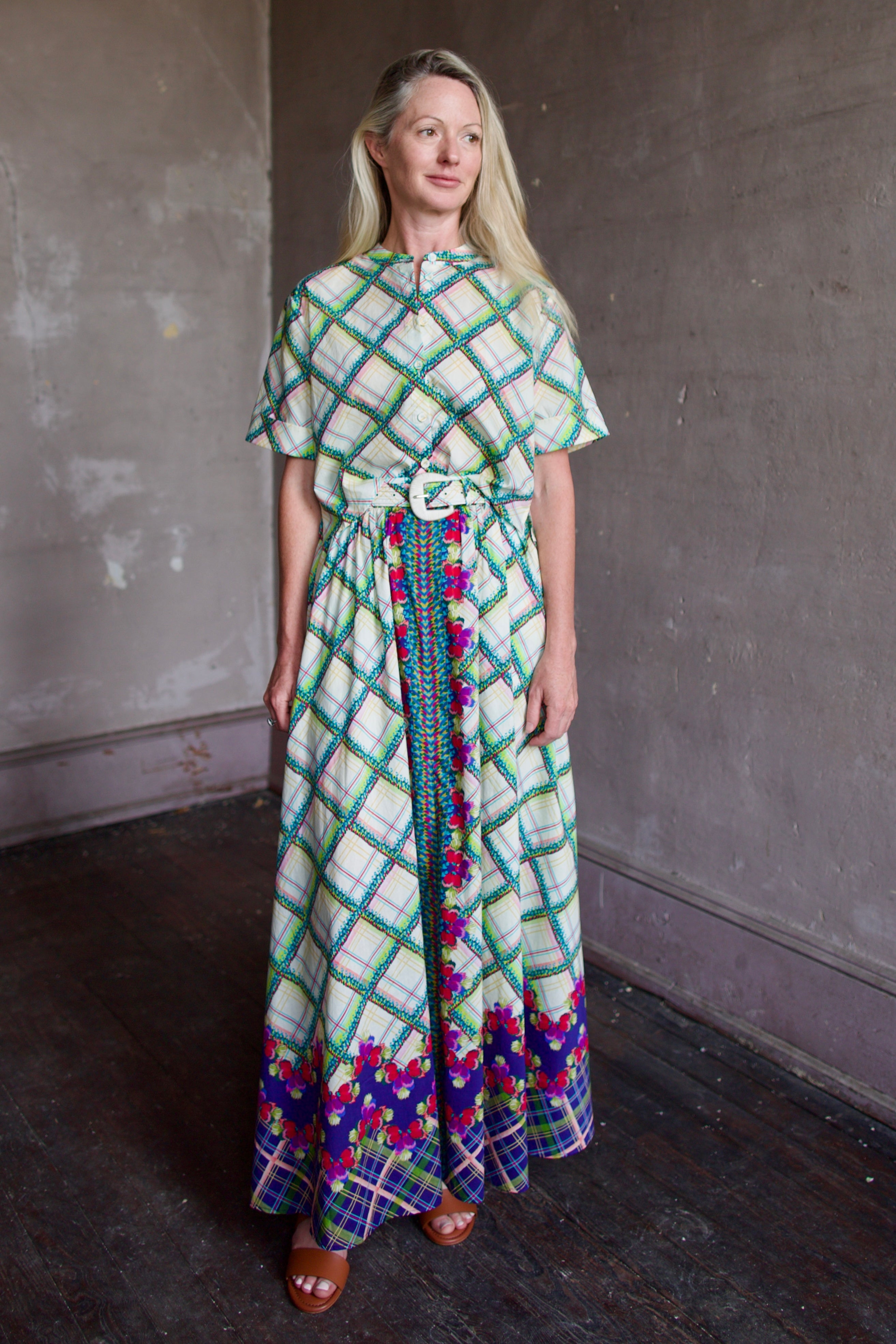 Mature woman wearing the Saloni Jude-B short sleeve plaid button up crop top crafted in cotton with happy diagonal green plaid expertly aligned pattern and matching skirt as a set