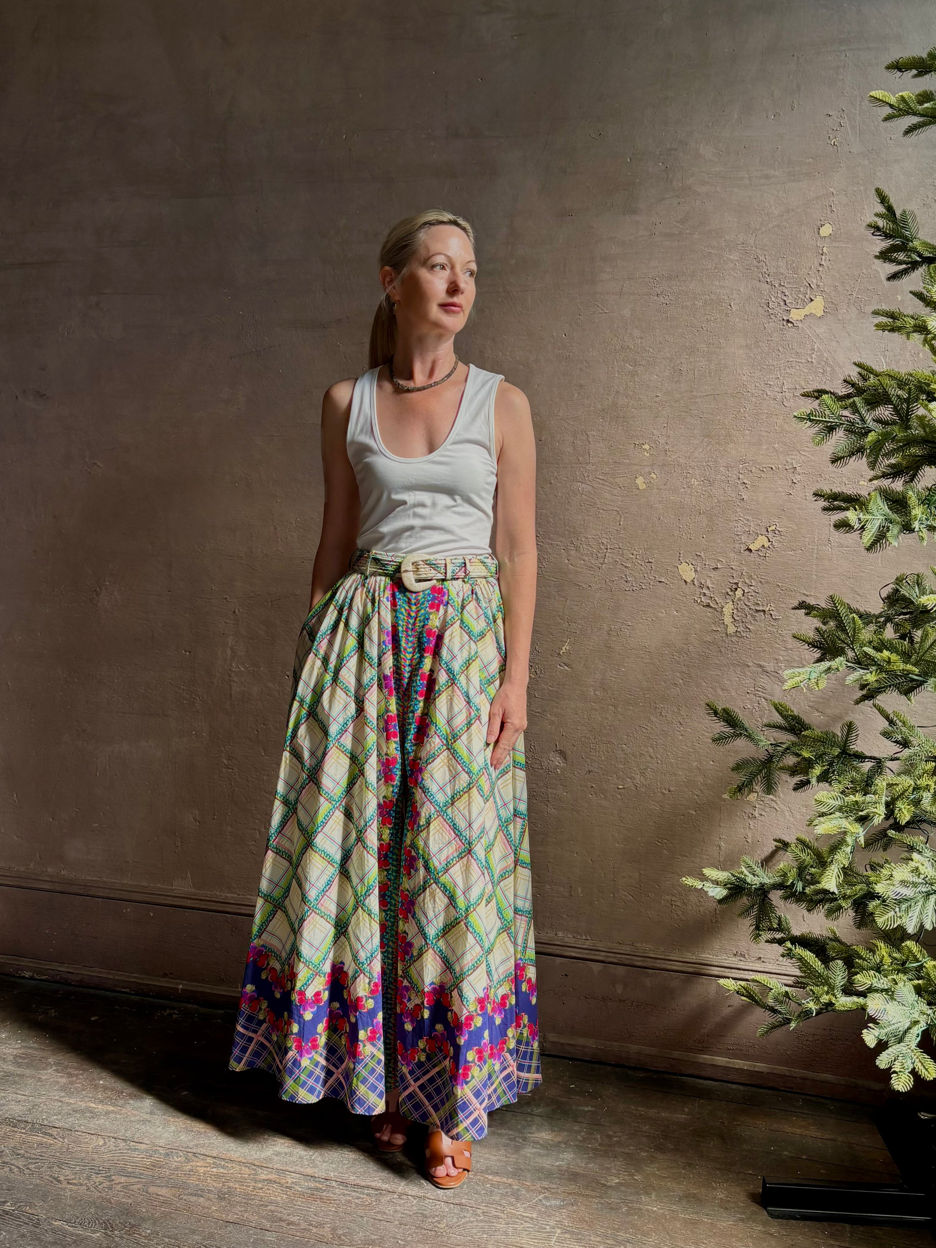 Mature woman reviewing Saloni Judi maxi plaid skirt with matching belt. This cotton A-line skirt is trimmed in pansies down front and bottom with front opening for additional ventilation