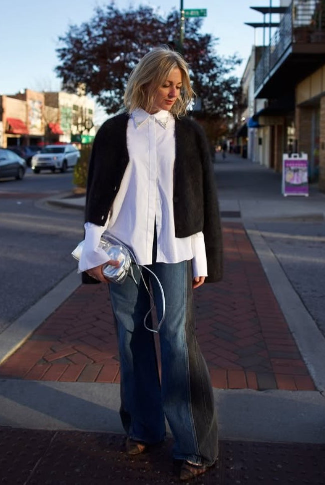 Model holding the Italian leather Mini Cloud clutch by high-end designer Mansur Gavriel in metallic silver