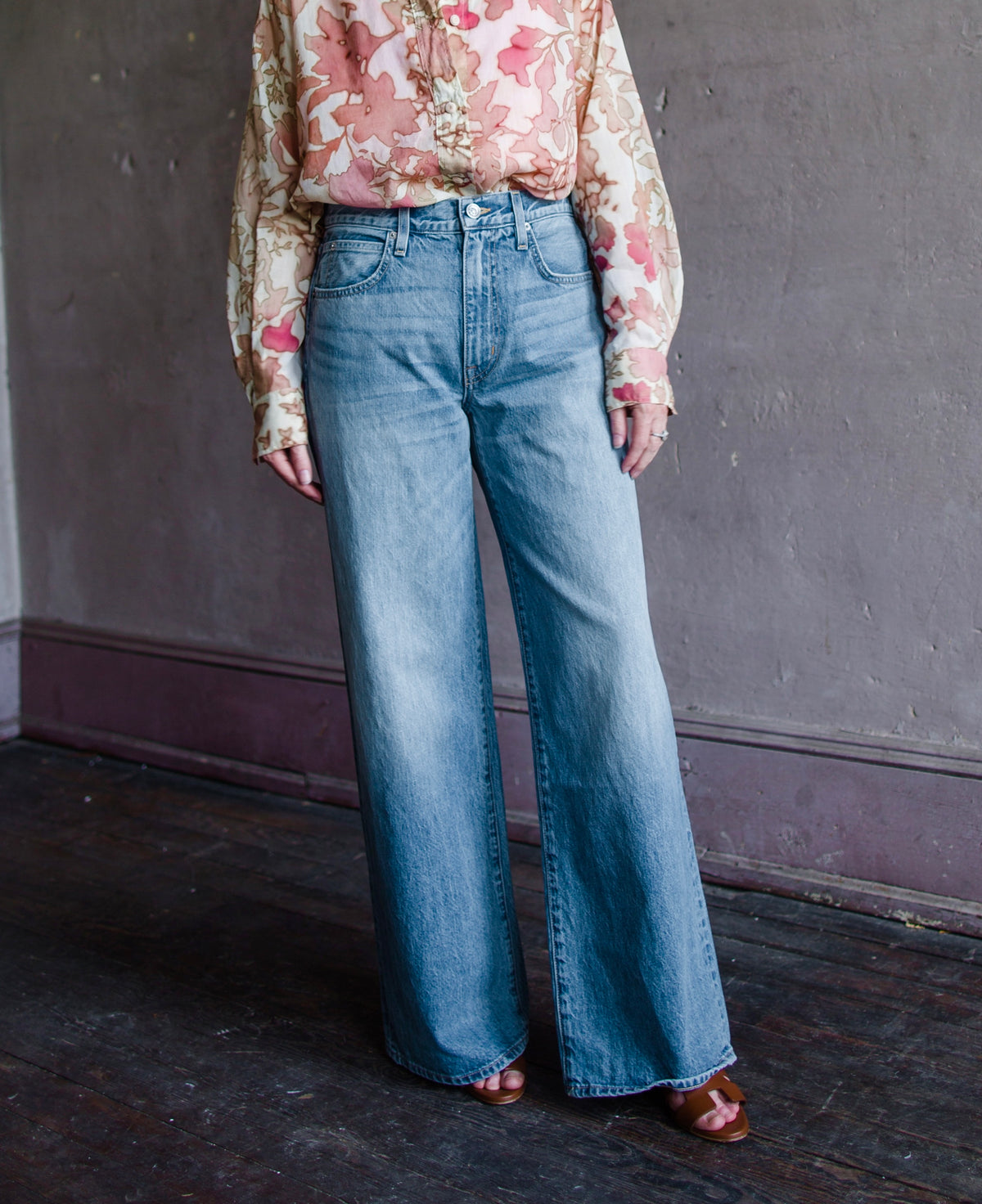 Mature woman wearing Slvrlake Selena 100% rigid cotton jeans high rise full length wide leg medium wash