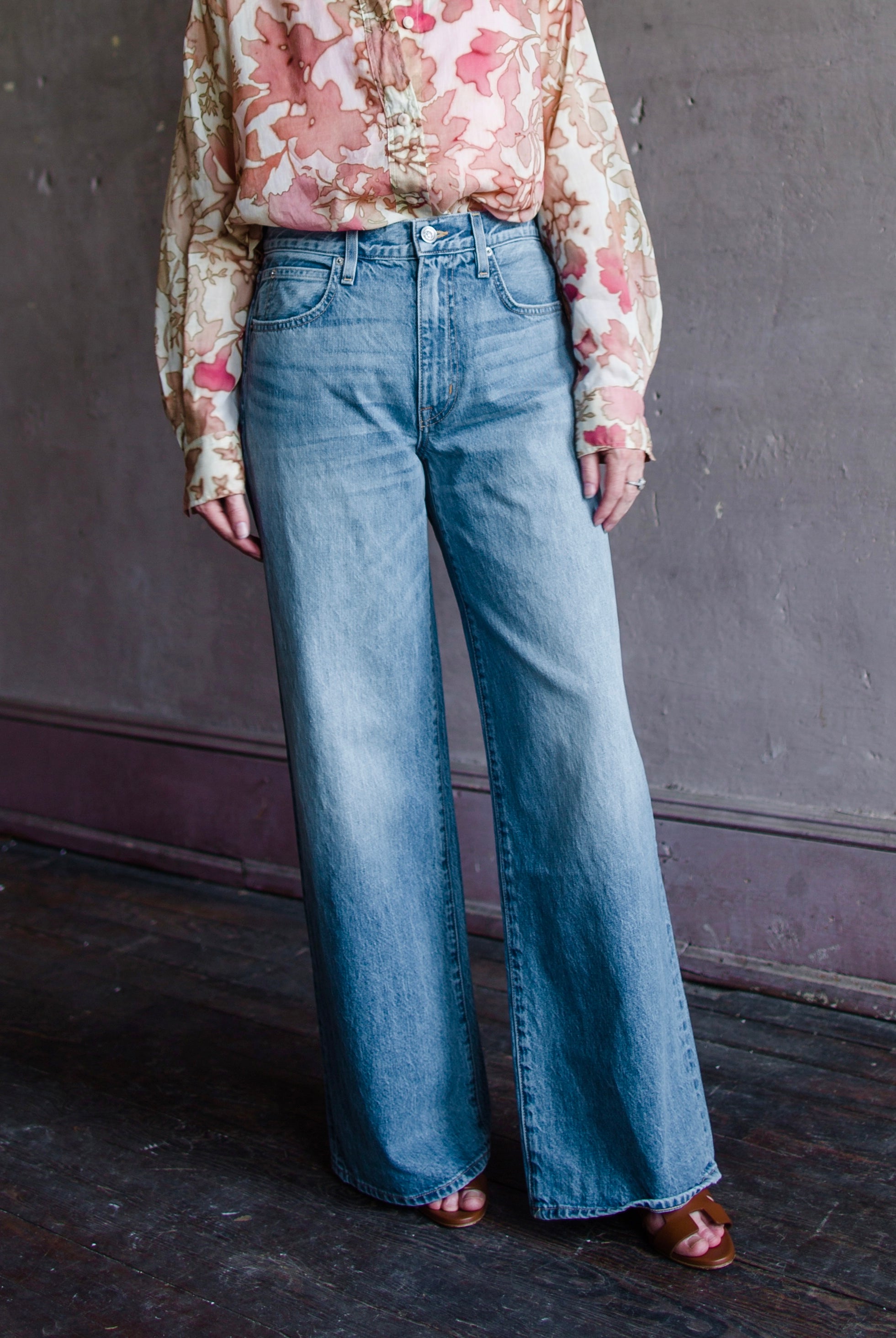Image featuring a woman wearing the Selena 100% rigid cotton jeans by Slvrlake with a mid rise, full length wide leg.