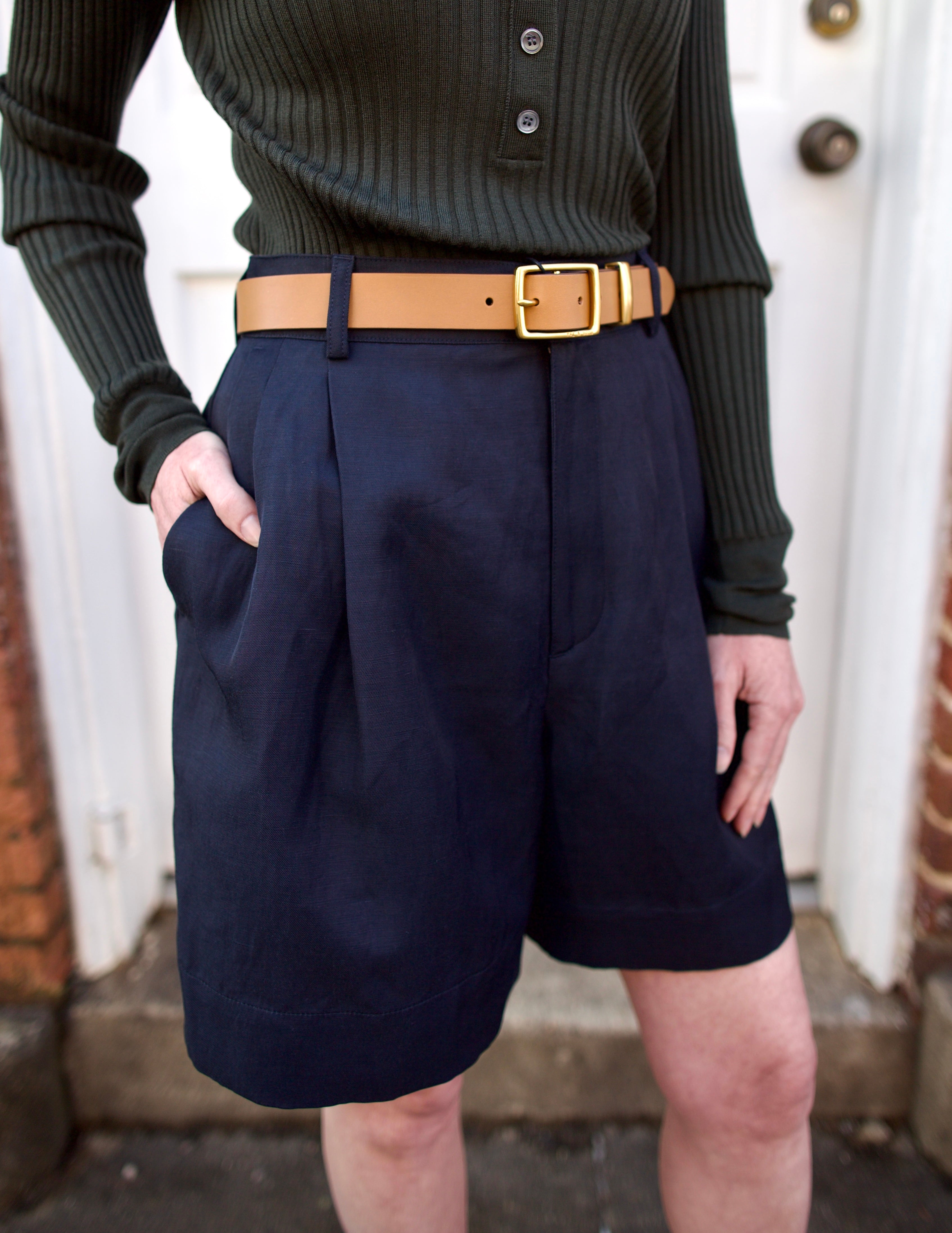 Close up of a woman wearing the Soeur Ribbed Henley, Rag and Bone Boyfriend Belt and Soeur Dawson Shorts