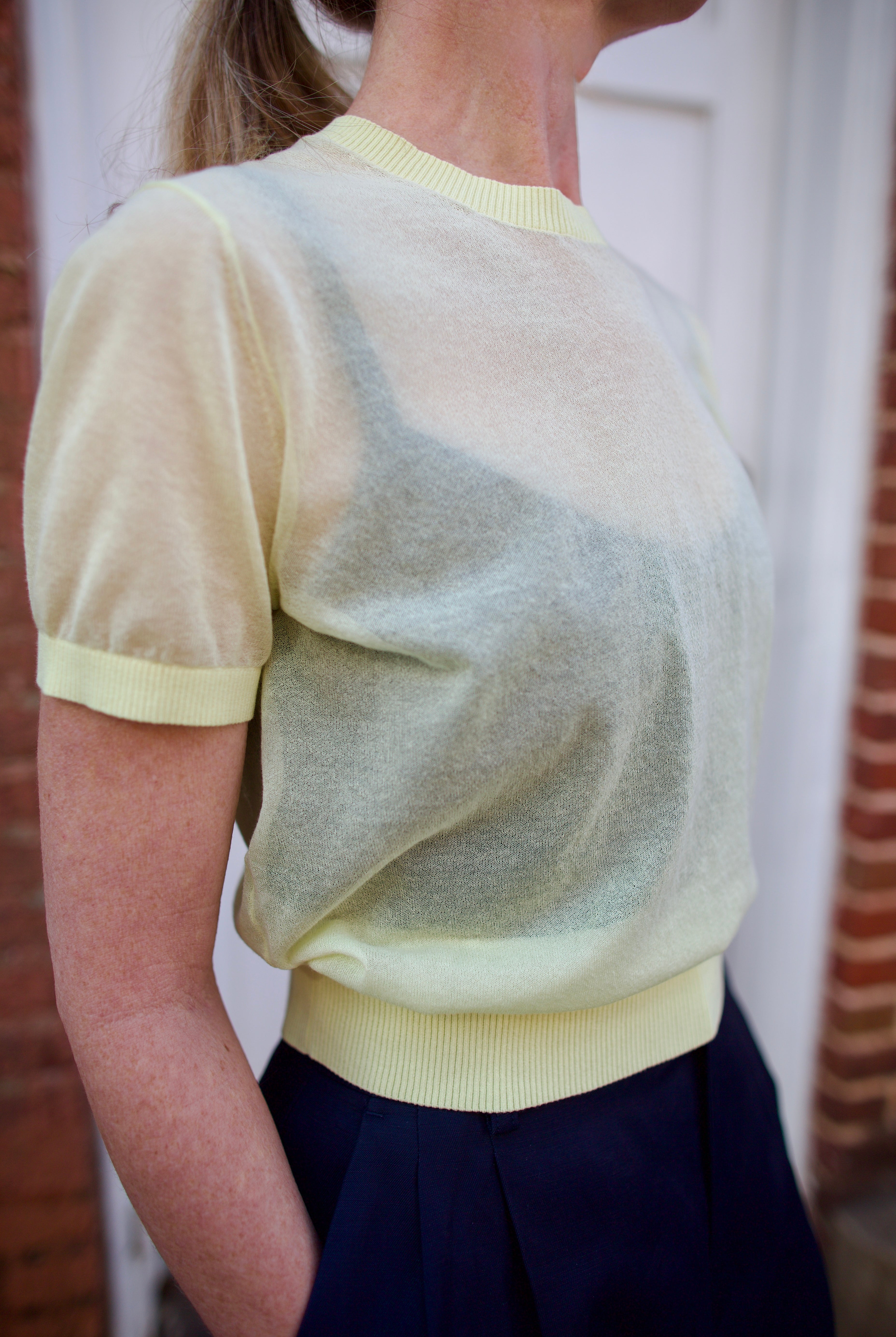 Close up image of a woman wearing the Soeur Dua Pullover and Tailored Shorts