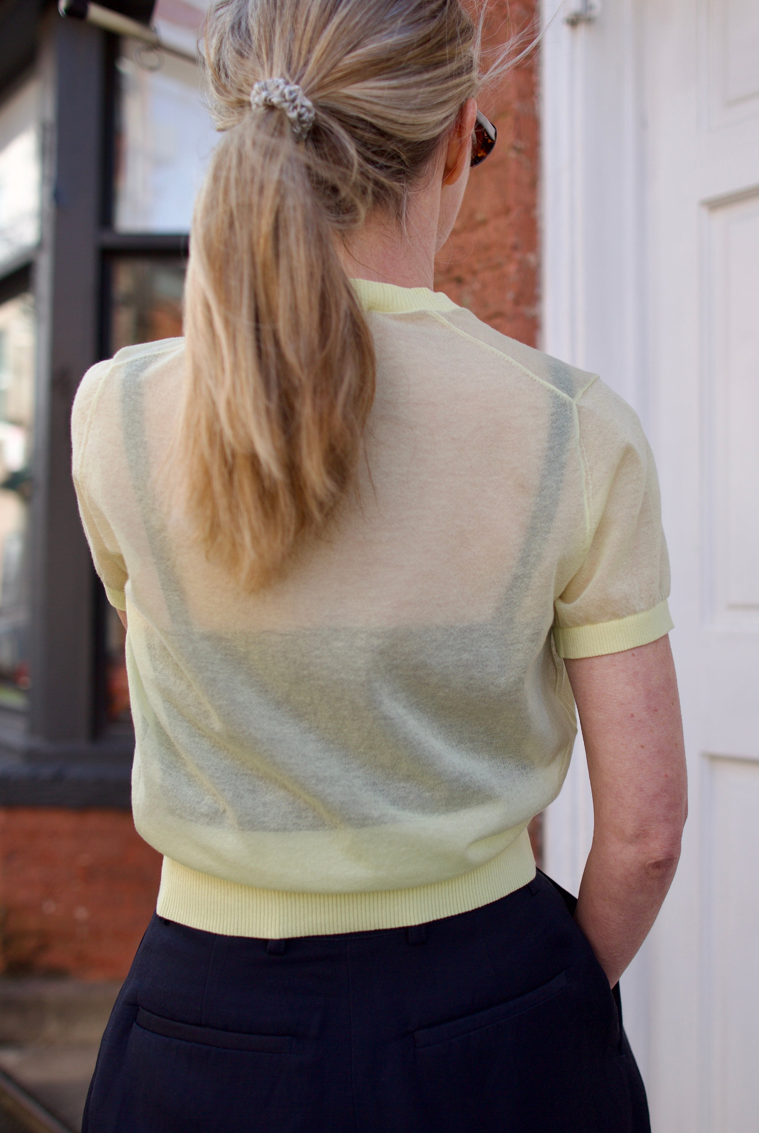 Back image of a woman wearing the Soeur Dua Pullover and tailored shorts
