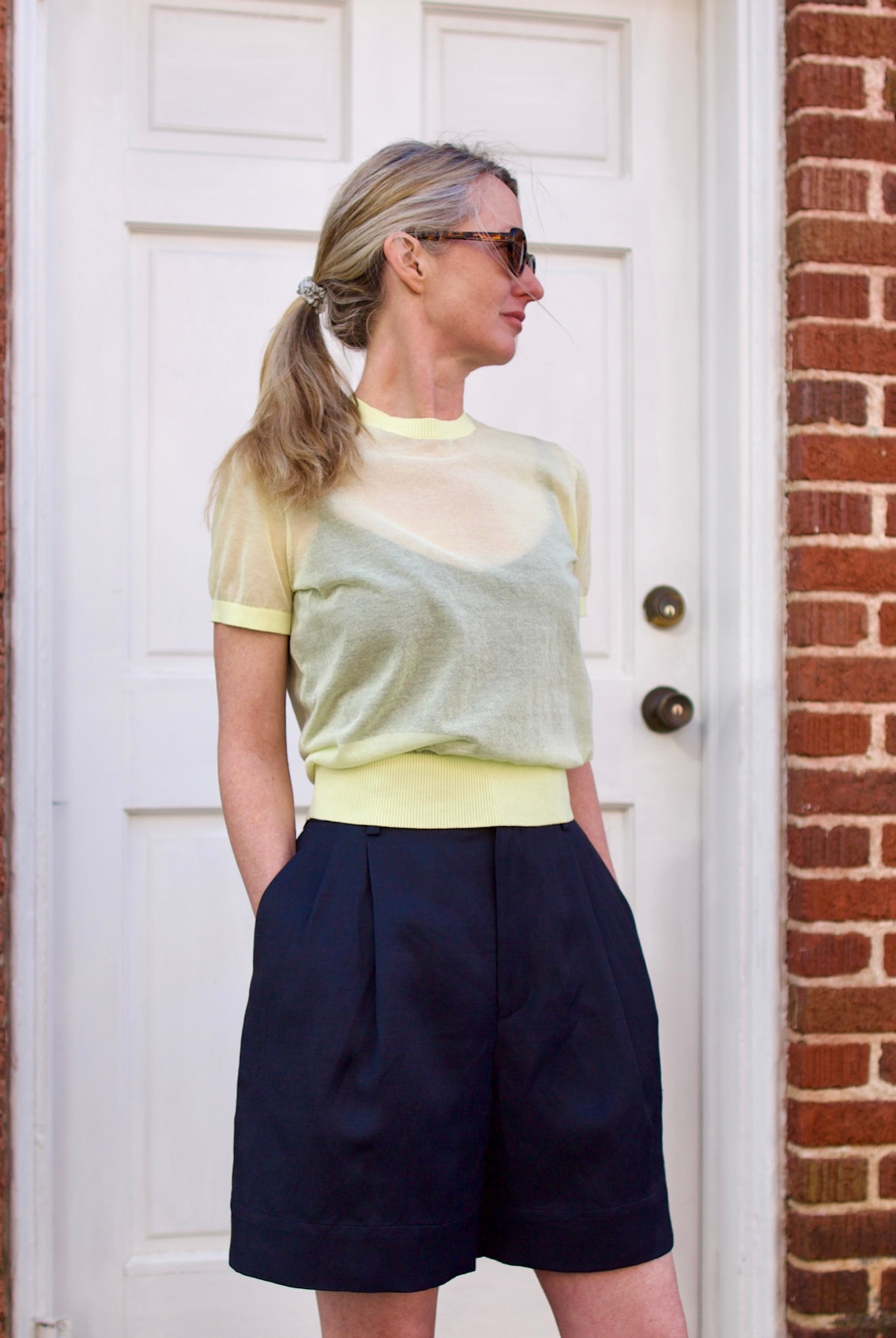 Image of a woman wearing the Soeur Dua Sheer Pullover and Dawson Shorts