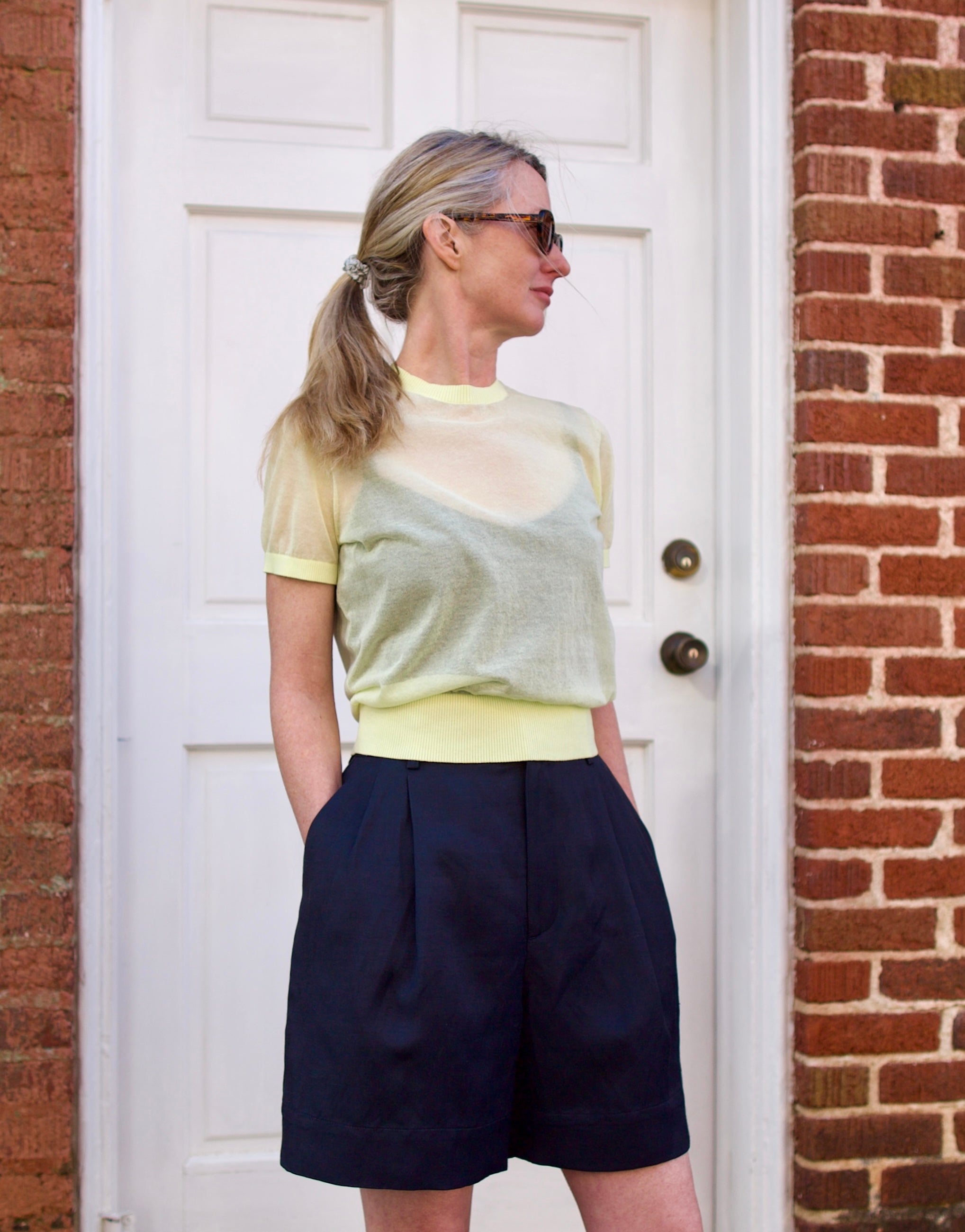 Image of a woman wearing the Soeur Dua Sheer Pullover and Dawson Shorts