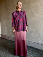 Image of mature woman wearing Trovata Blake Oversized premium cotton button down long sleeve Shirt in Mulled Wine Plaid