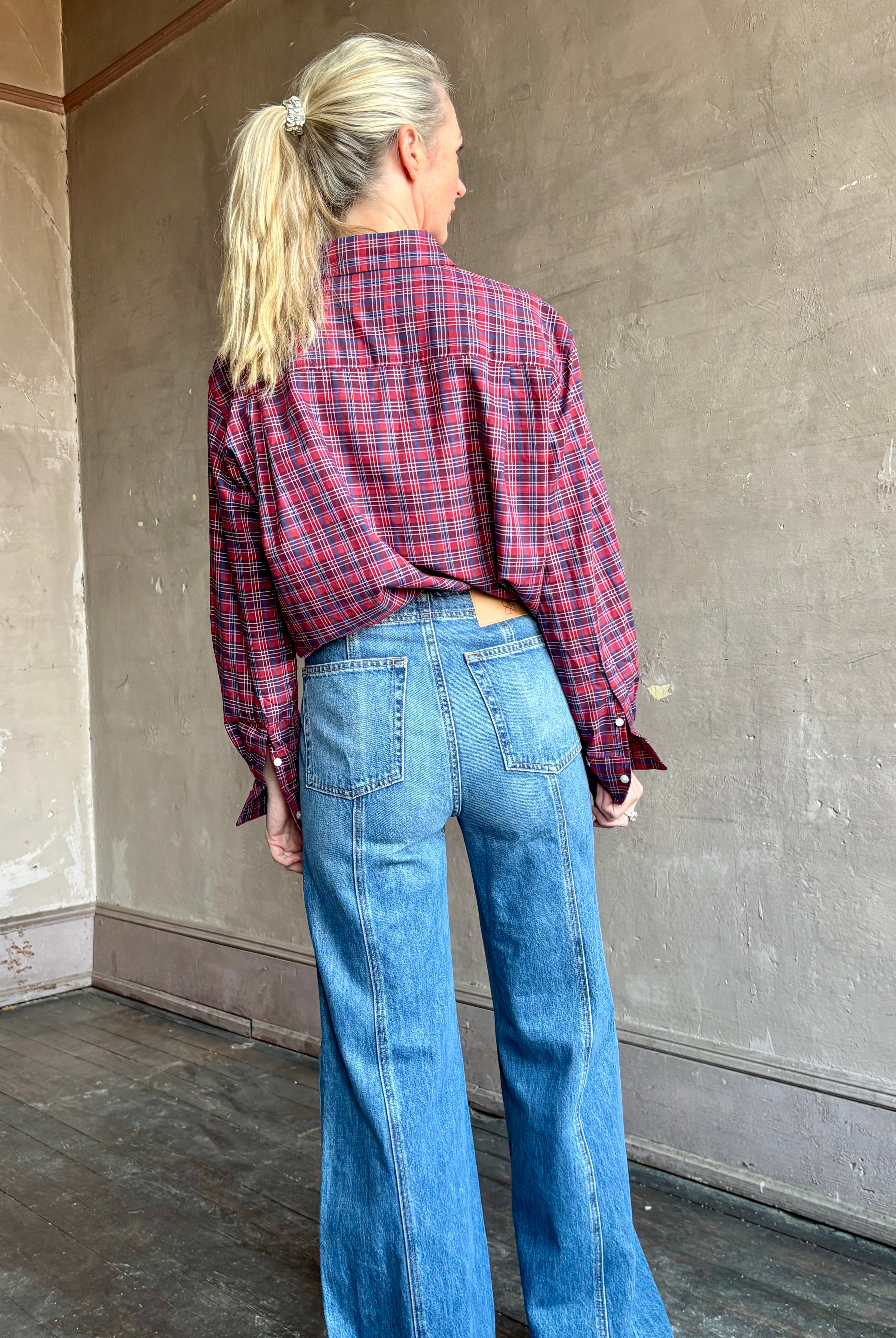 Image of mature woman wearing Trovata Blake Oversized premium cotton button down long sleeve Shirt in Mulled Wine Plaid