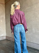 Image of mature woman wearing Trovata Blake Oversized premium cotton button down long sleeve Shirt in Mulled Wine Plaid