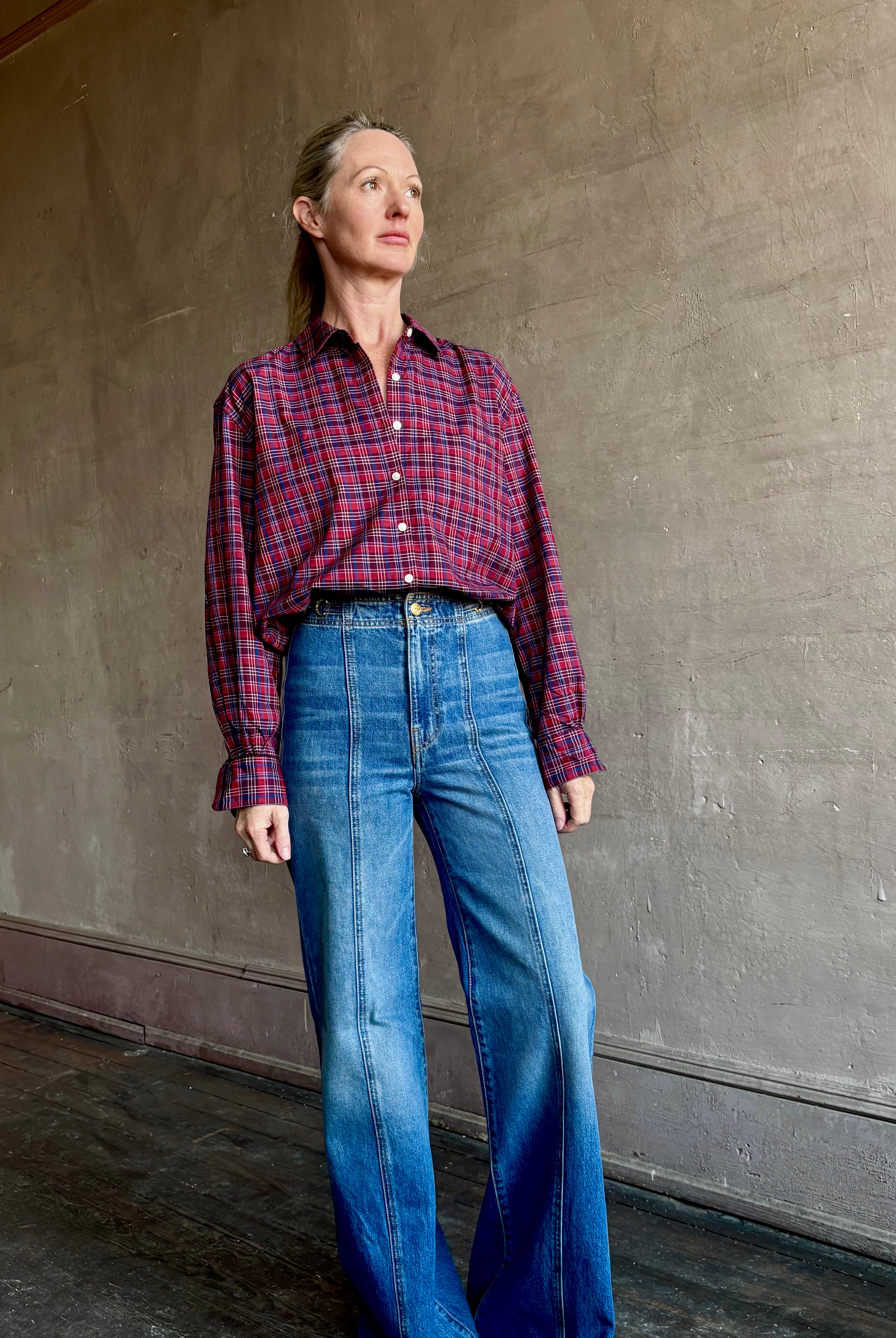 Image of mature woman wearing Trovata Blake Oversized premium cotton button down long sleeve Shirt in Mulled Wine Plaid