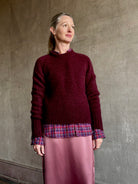 Image of mature woman wearing Trovata Blake Oversized premium cotton button down long sleeve Shirt in Mulled Wine Plaid
