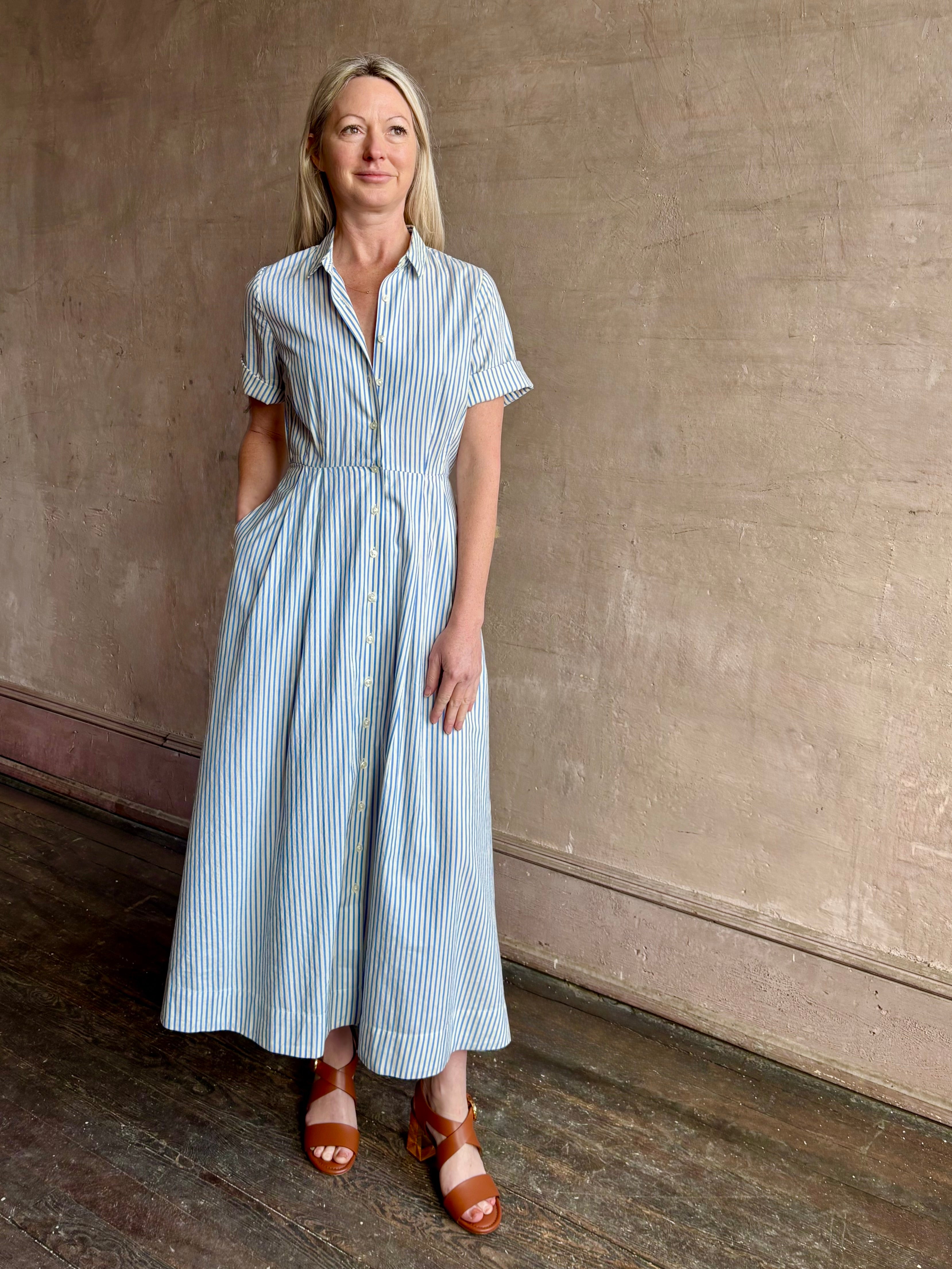 Image of woman wearing timeless TROVATA Aster A-line cotton shirt maxi Dress in Seaside blue and white Stripe with hidden seam pockets