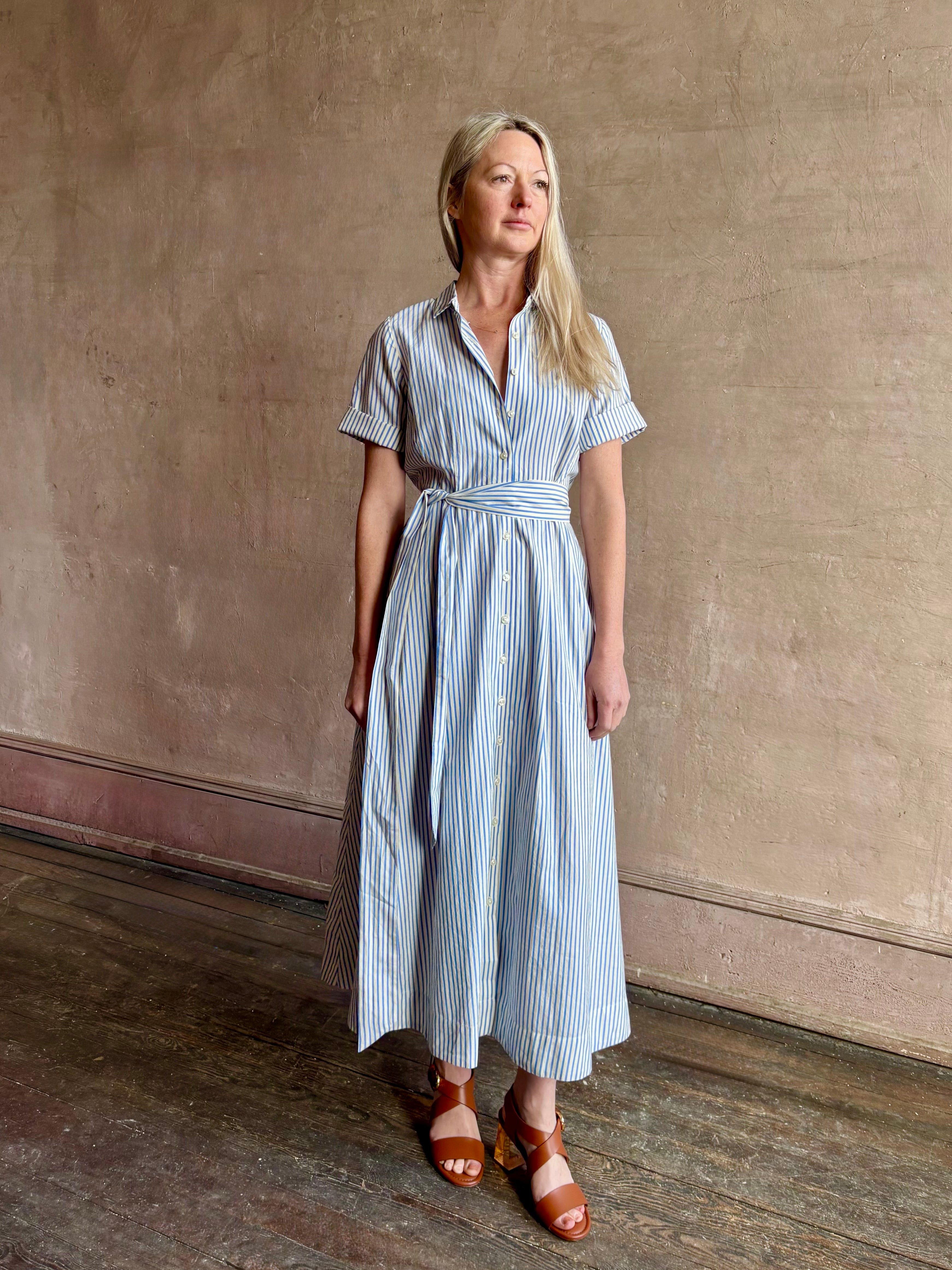 Image of woman wearing timeless TROVATA Aster A-line cotton shirt maxi Dress in Seaside blue and white Stripe with hidden seam pockets