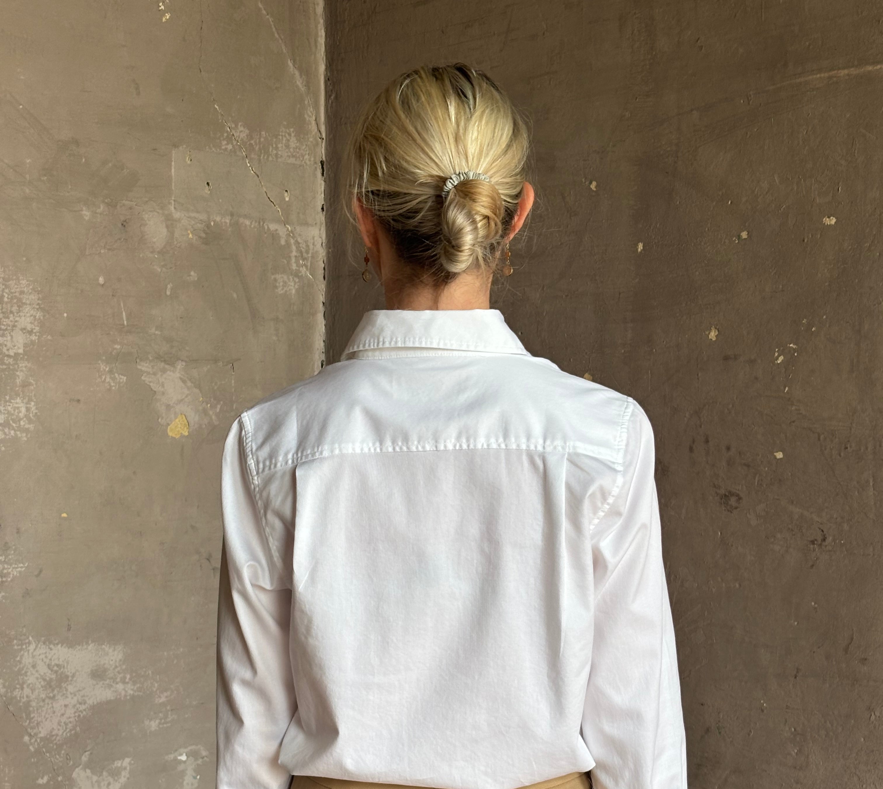 woman wearing white Trovata Justine blouse collared V-neck button-front closure cuffed long sleeves classic silhouette