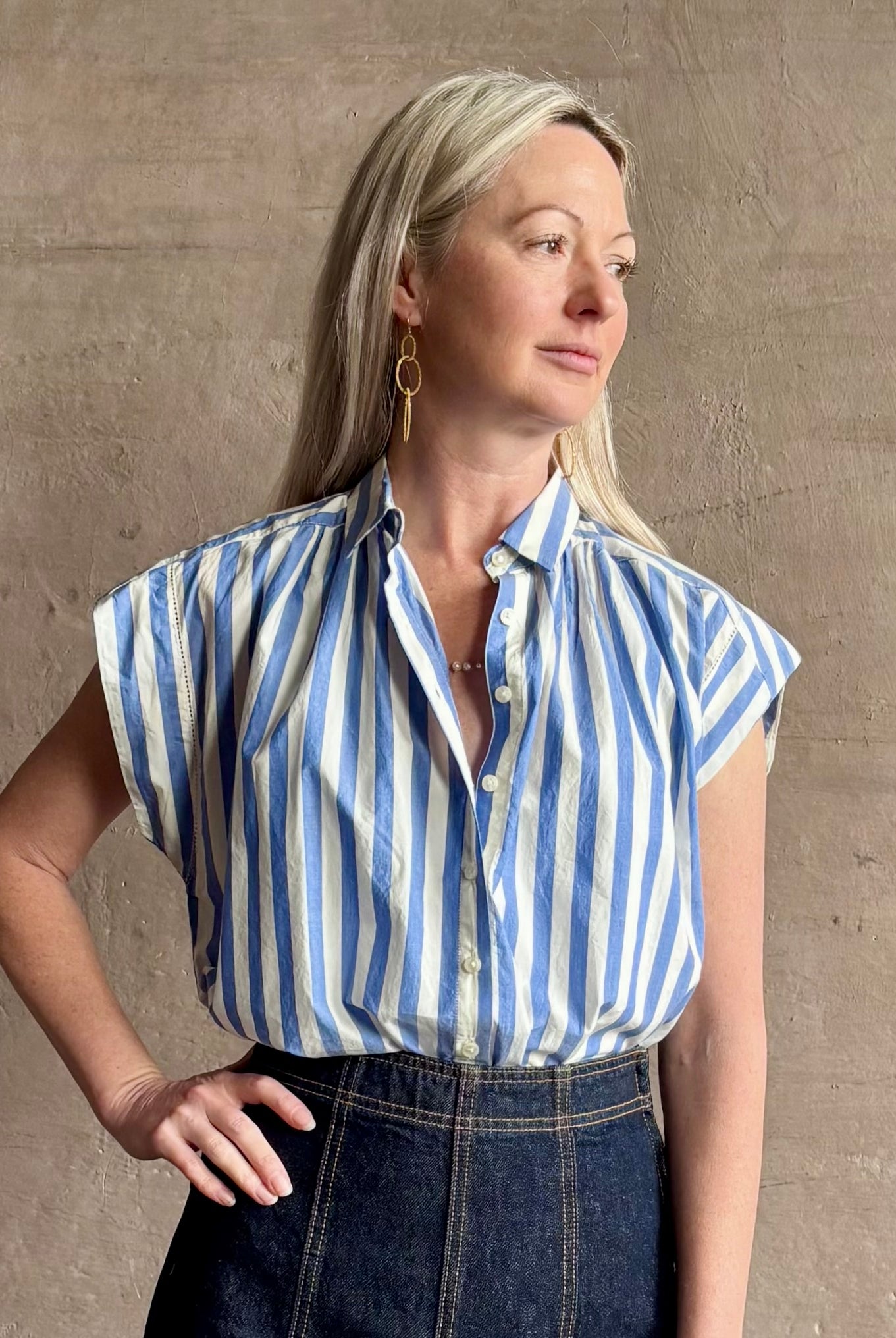 Mature woman wearing elevated everyday short sleeve cotton button-down Della Shirt from Trovata in a playful blue and white summer stripe