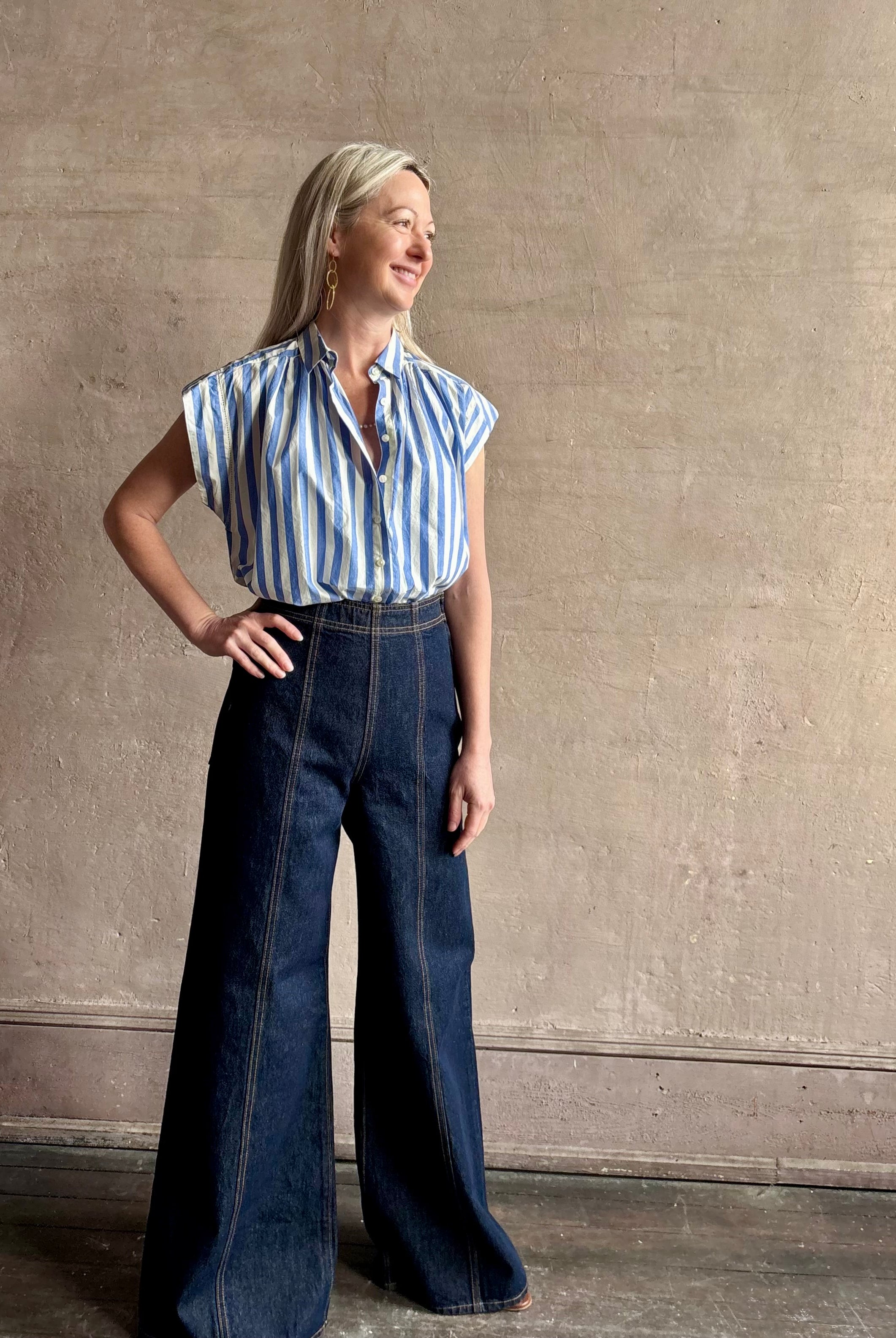 Mature woman wearing elevated everyday short sleeve cotton button-down Della Shirt from Trovata in a playful blue and white summer stripe