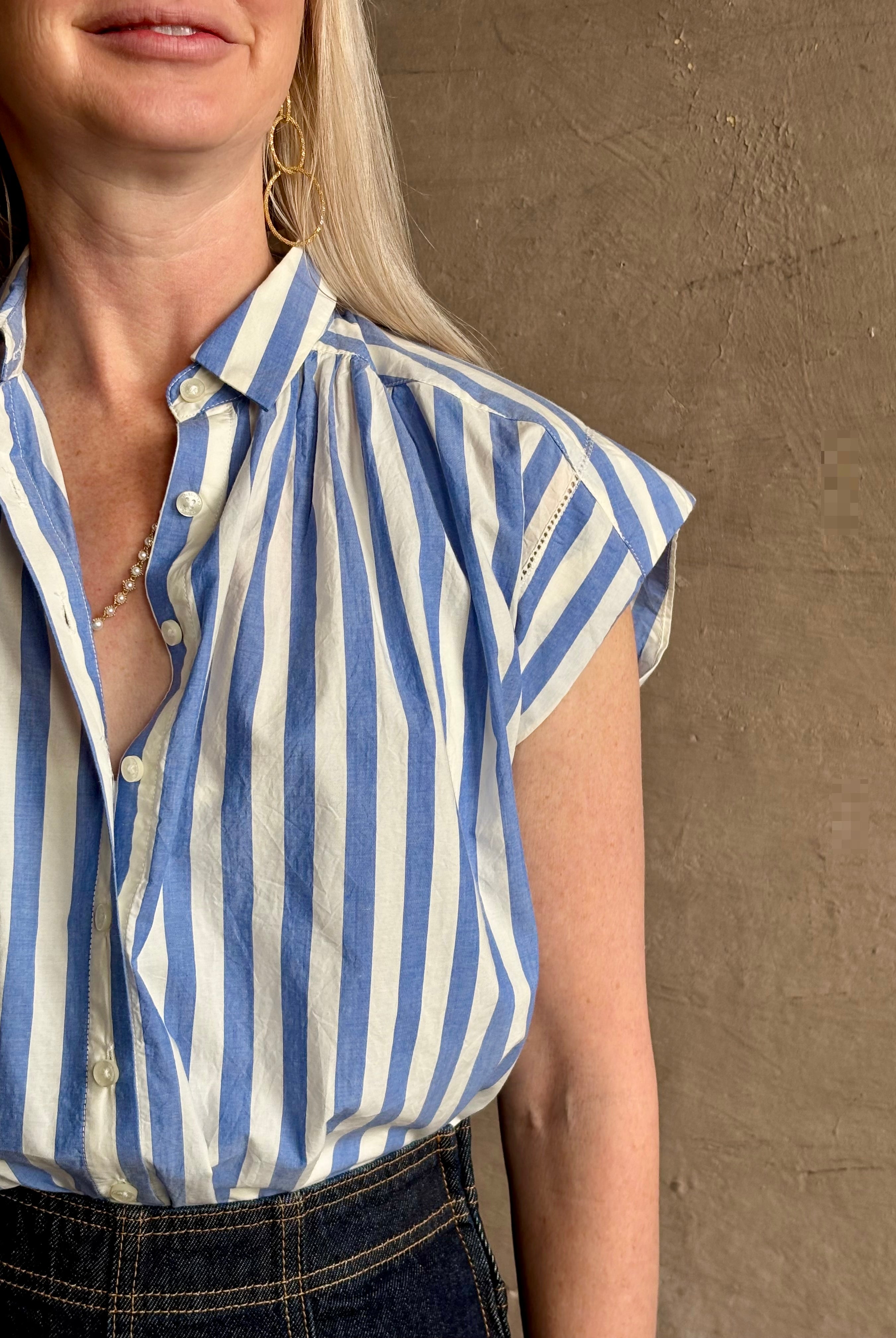Mature woman wearing elevated everyday short sleeve cotton button-down Della Shirt from Trovata in a playful blue and white summer stripe