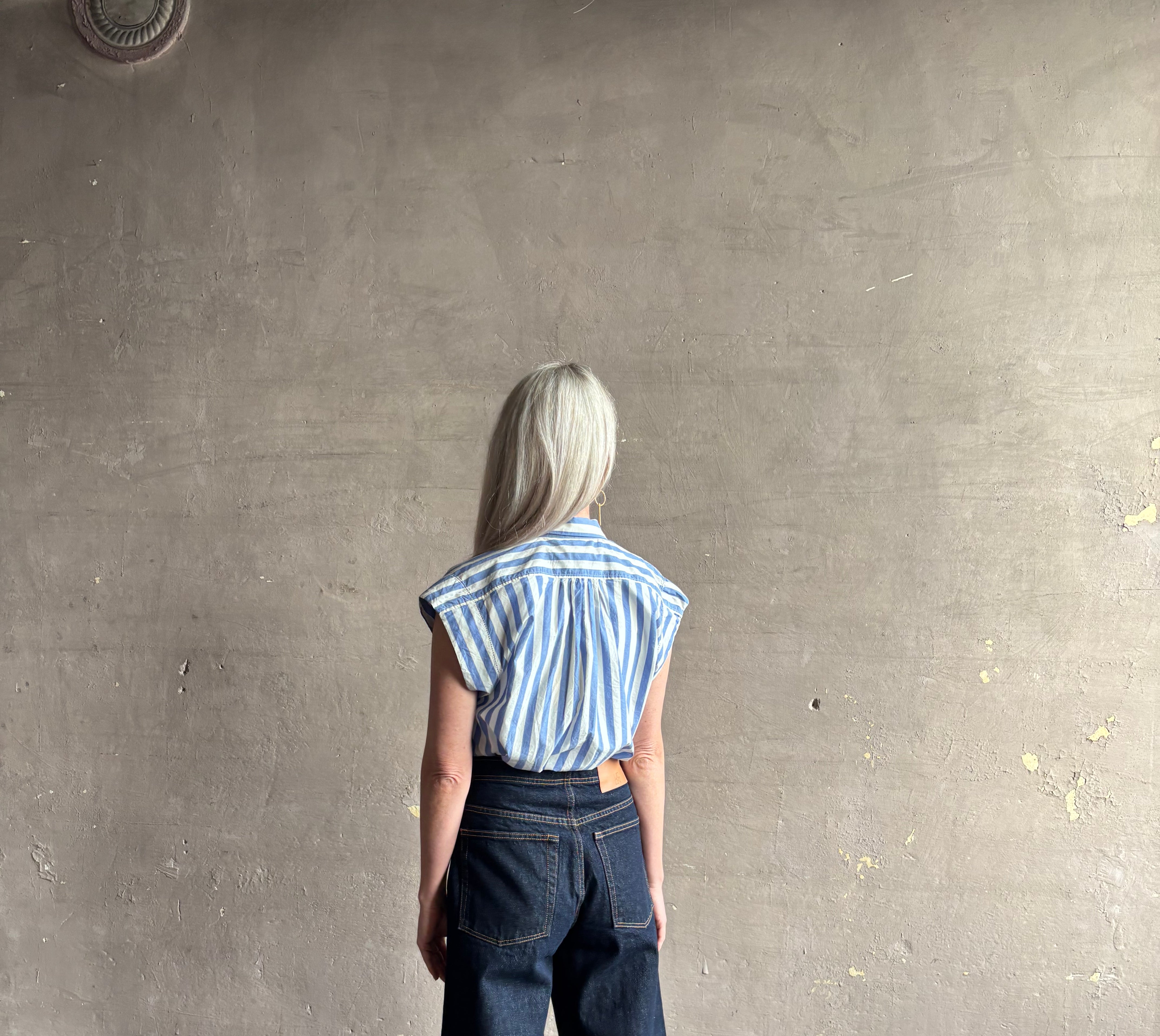 Mature woman wearing elevated everyday short sleeve cotton button-down Della Shirt from Trovata in a playful blue and white summer stripe