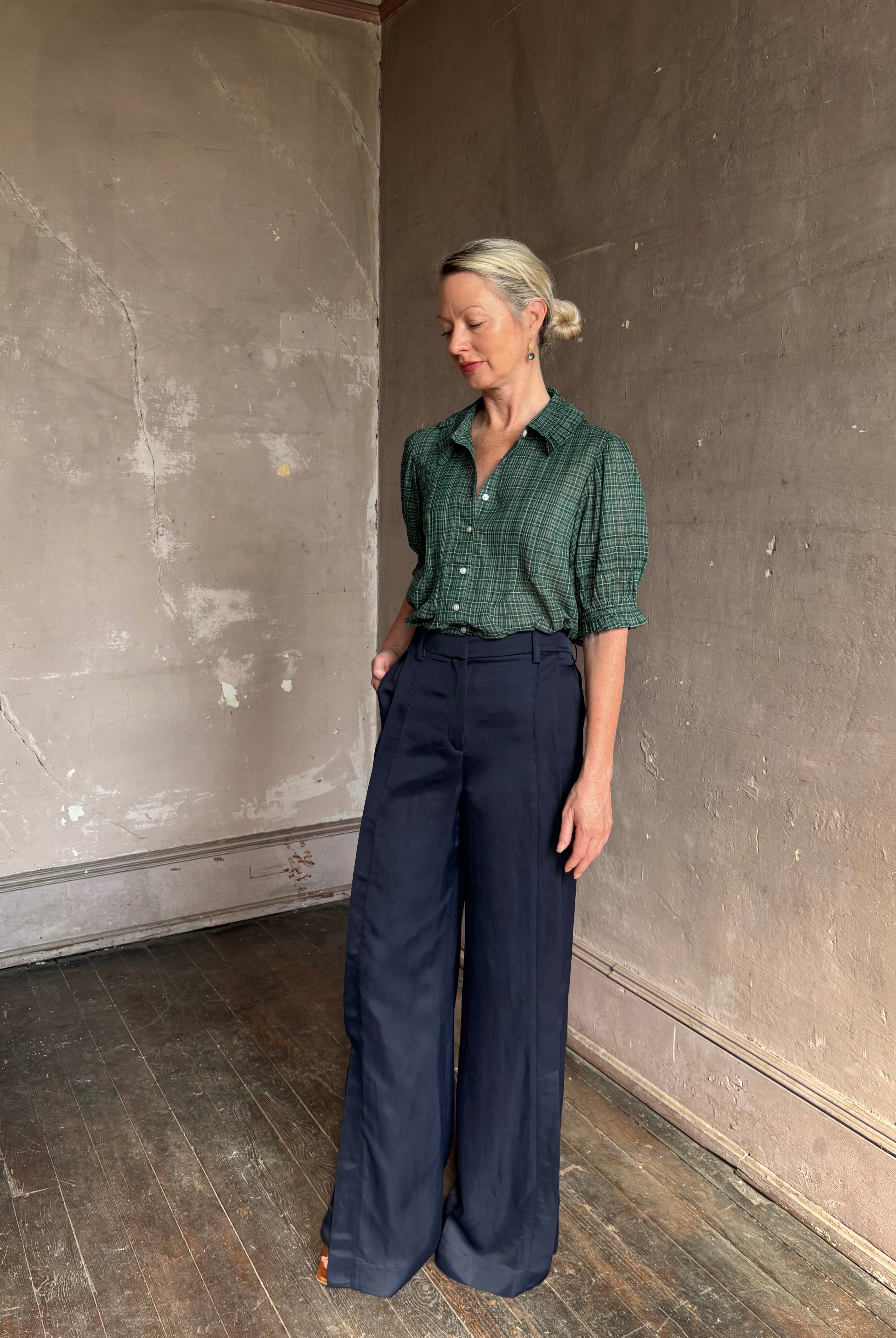 Mature woman wearing Trovata Jess green plaid short sleeve cotton poplin blouse with pintucking and peter pan collar