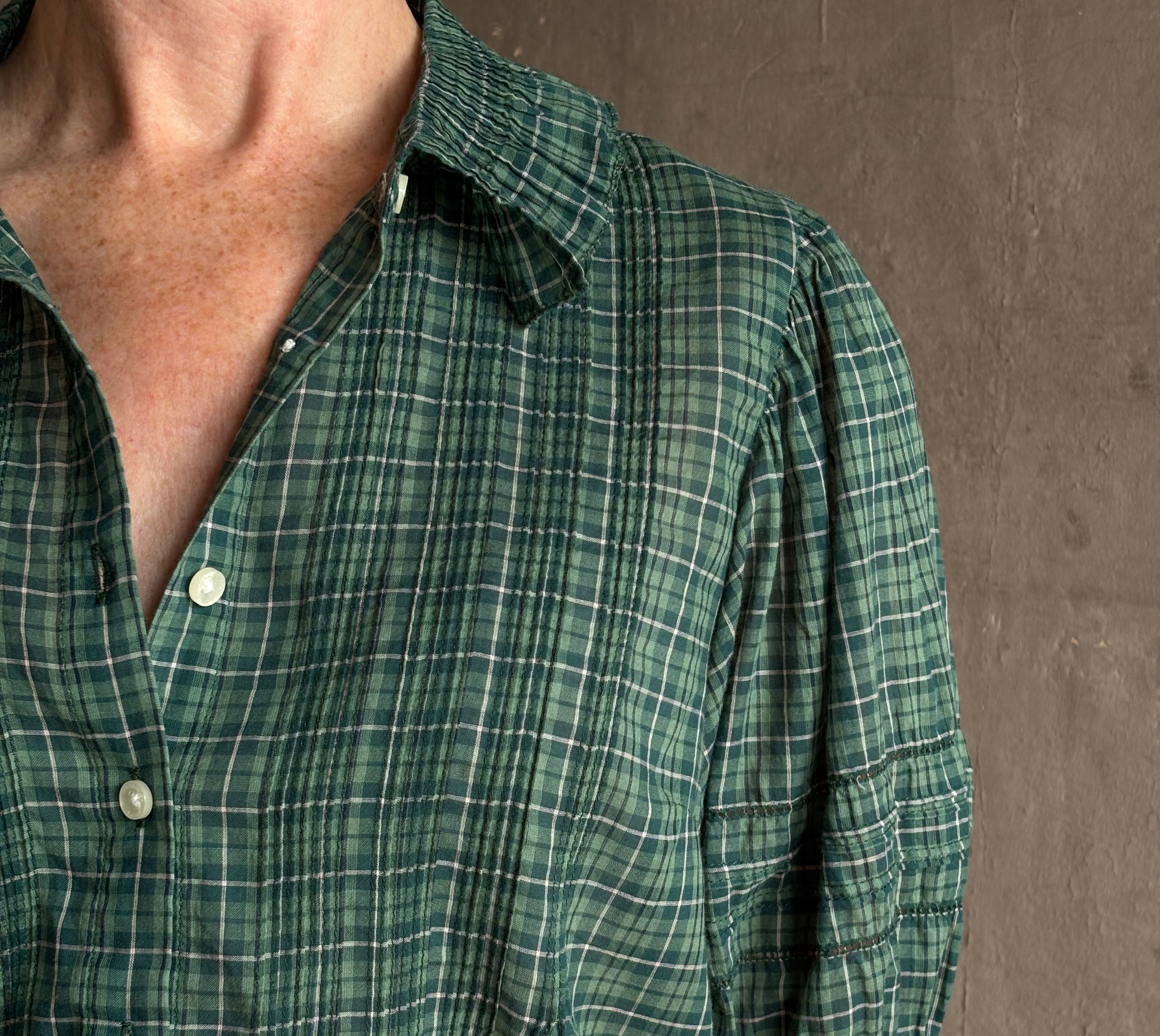 Mature woman wearing Trovata Jess green plaid short sleeve cotton poplin blouse with pintucking and peter pan collar