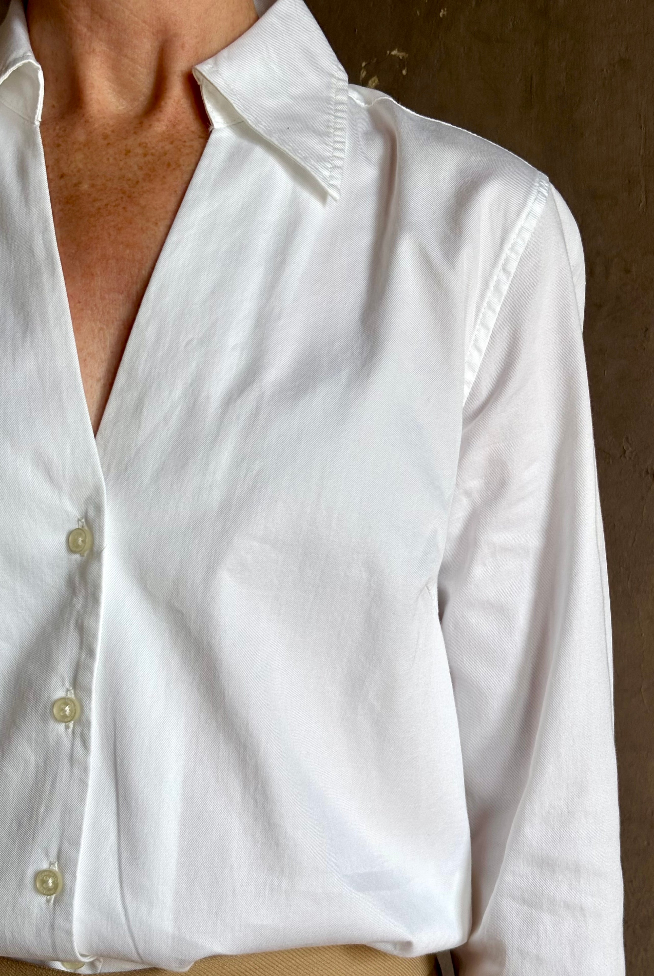 woman wearing white Trovata Justine blouse collared V-neck button-front closure cuffed long sleeves classic silhouette