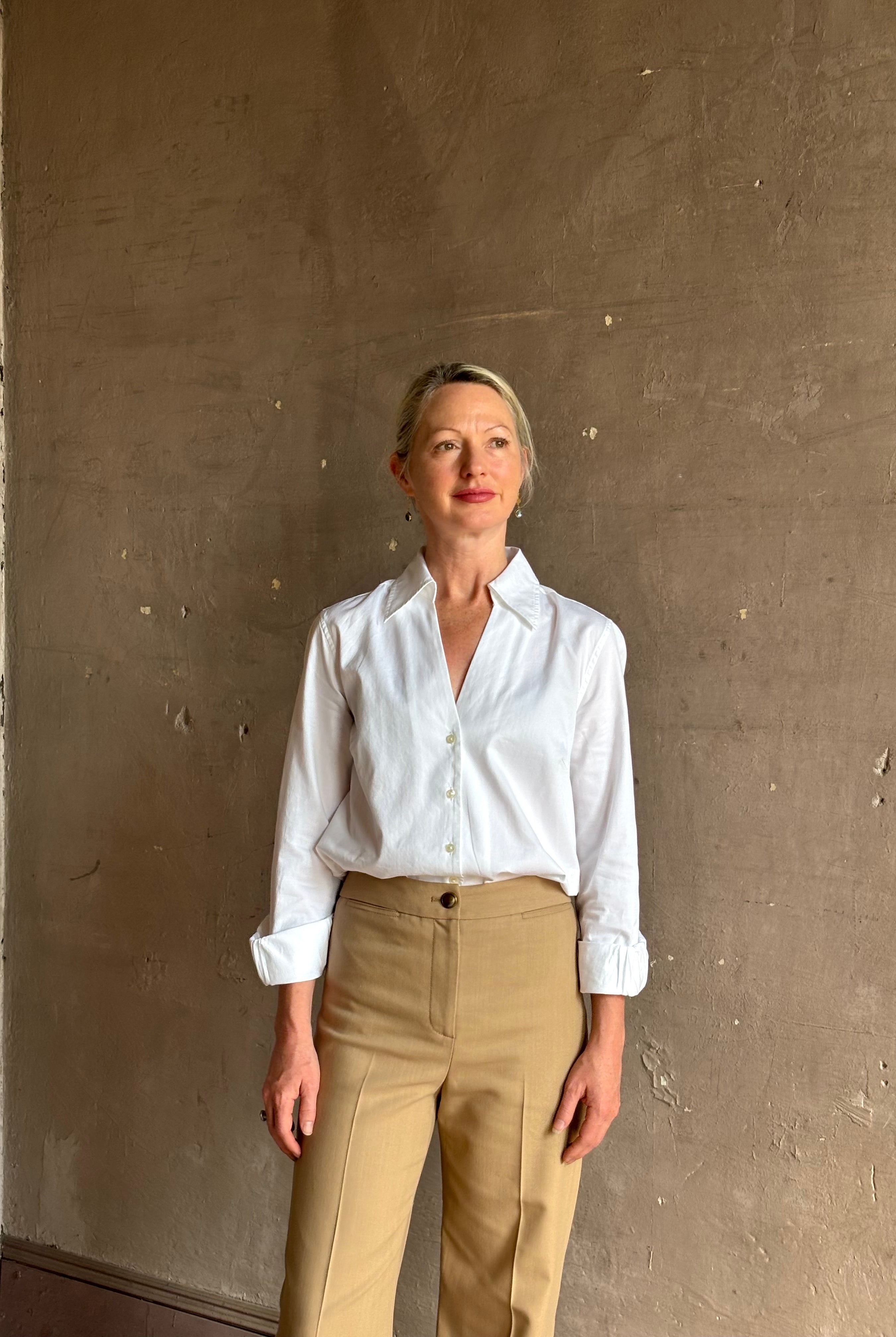 woman wearing white Trovata Justine blouse collared V-neck button-front closure cuffed long sleeves classic silhouette