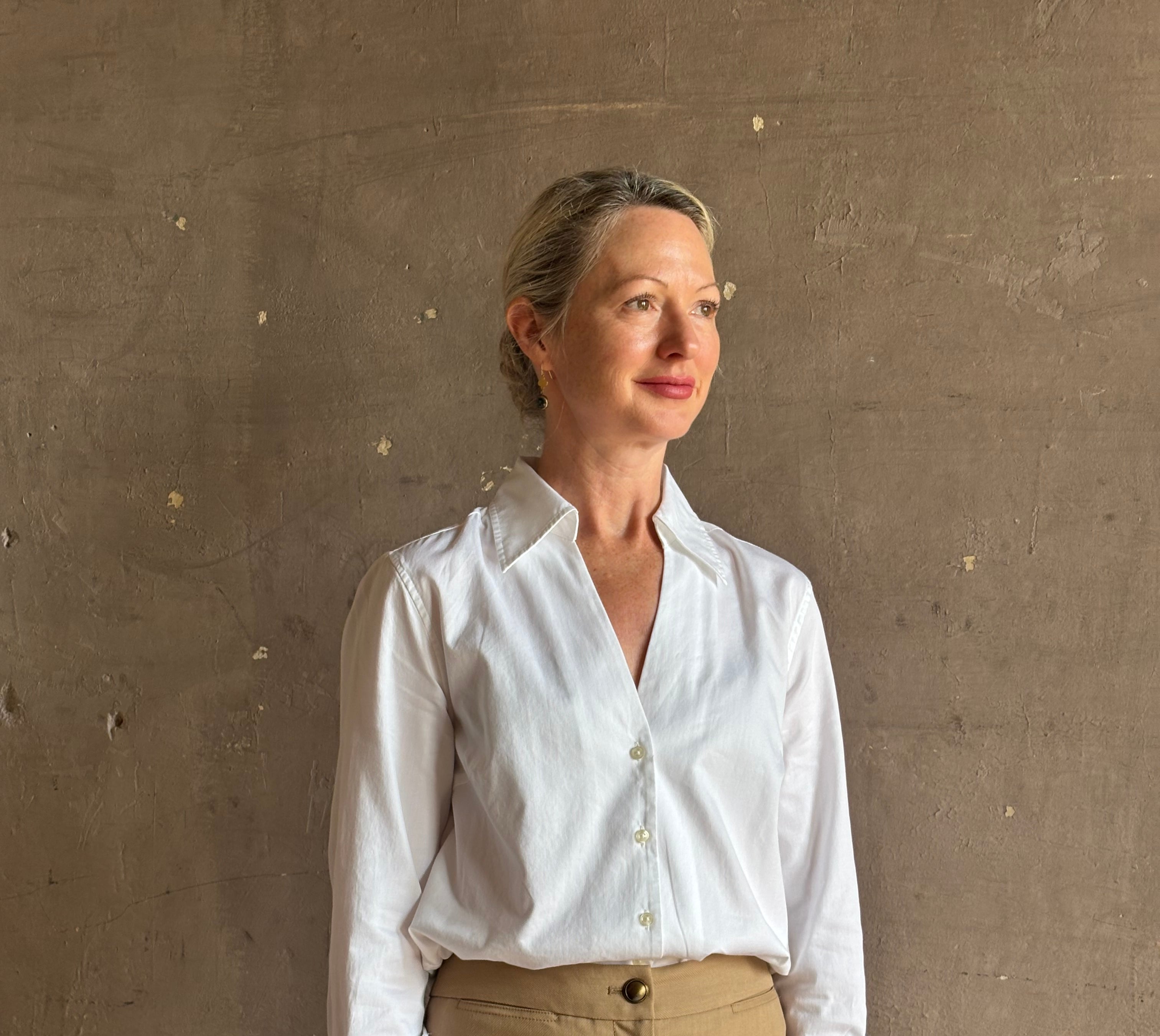 woman wearing white Trovata Justine blouse collared V-neck button-front closure cuffed long sleeves classic silhouette