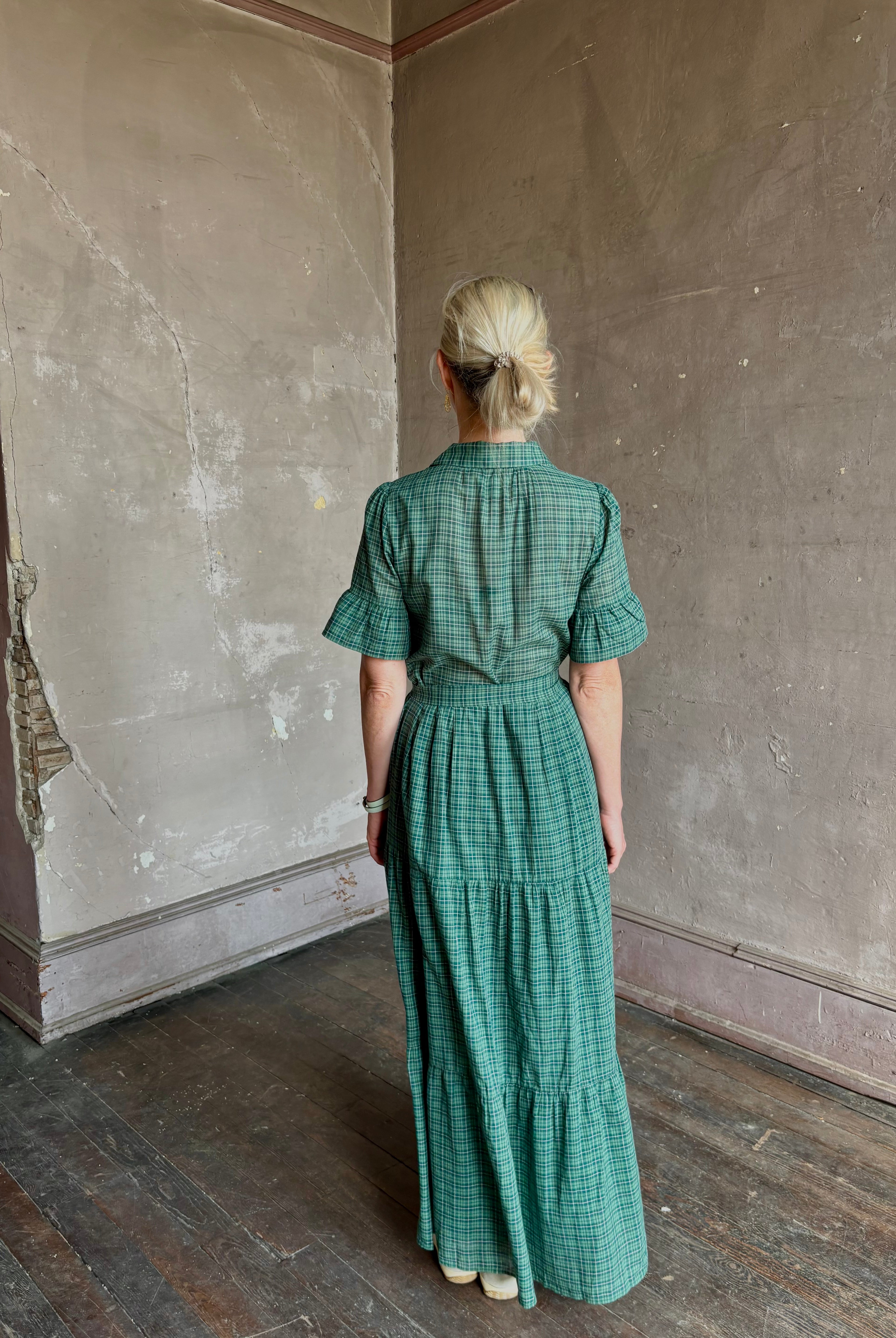 Mature woman wearing Trovata Martine button-up front cotton poplin green plaid maxi dress short sleeves and lightweight