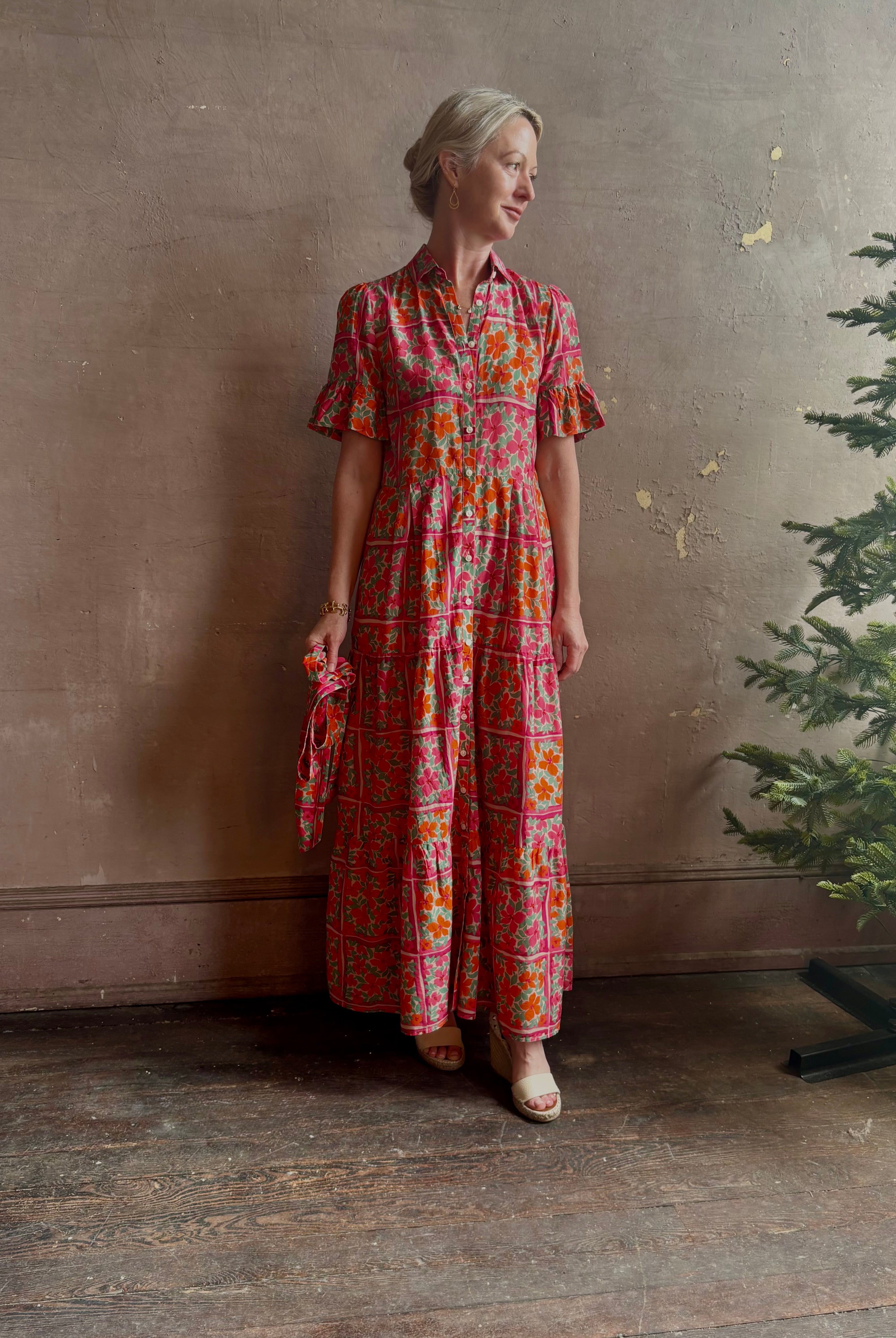 Mature woman wearing Martine maxi Dress from Trovata with button front, collar, short sleeves and self tile belt