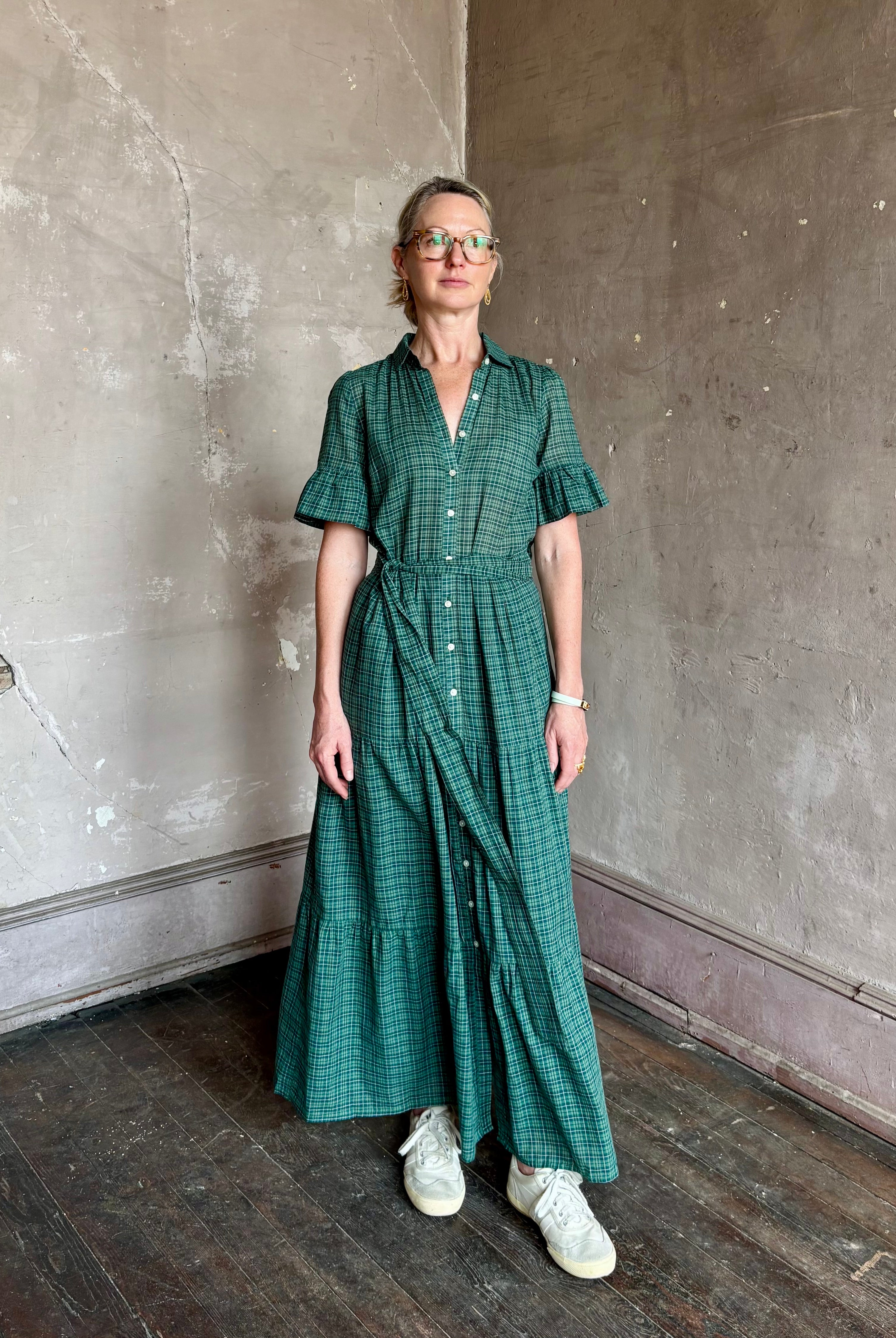 Mature woman wearing Trovata Martine button-up front cotton poplin green plaid maxi dress short sleeves and lightweight