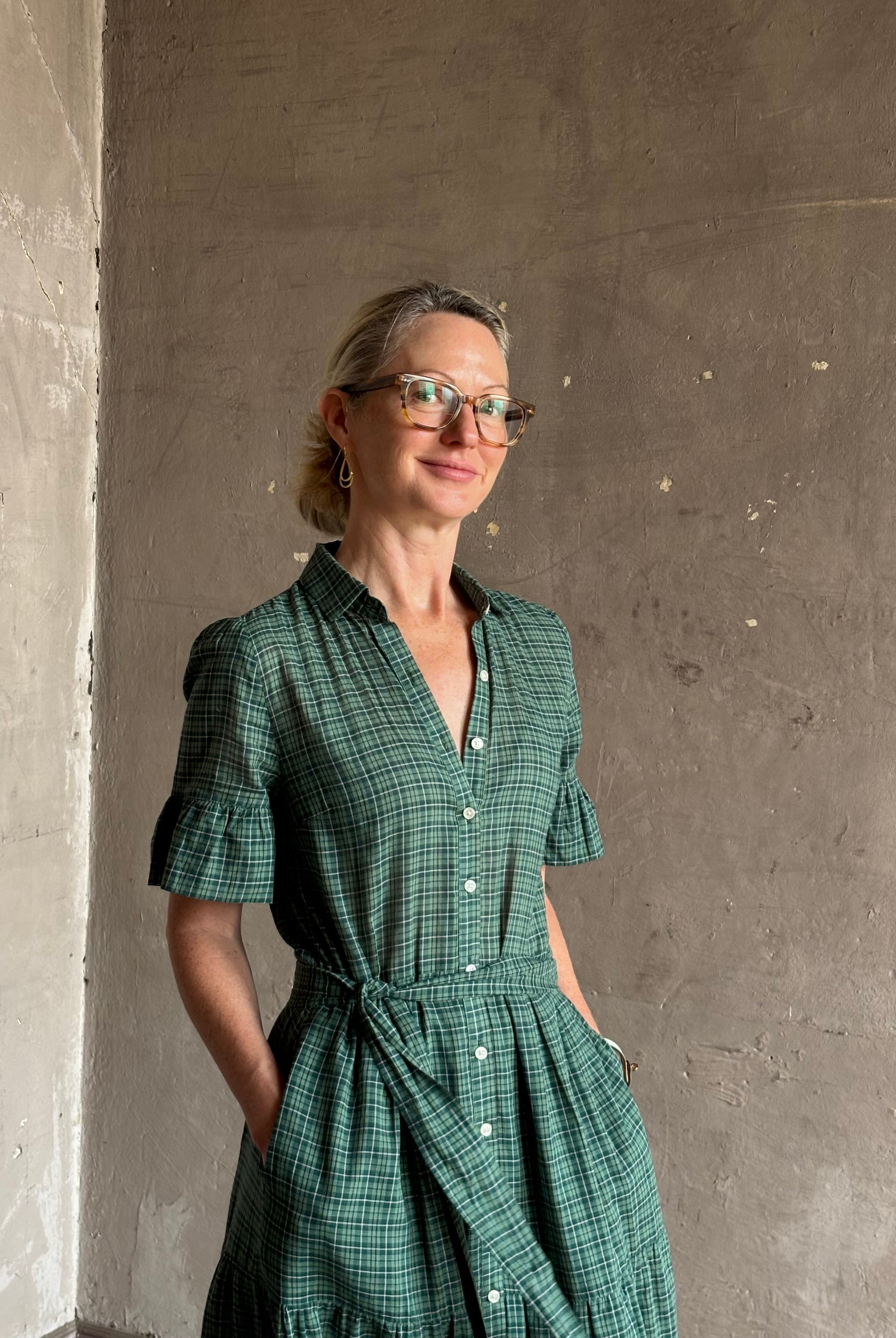 Mature woman wearing Trovata Martine button-up front cotton poplin green plaid maxi dress short sleeves and lightweight