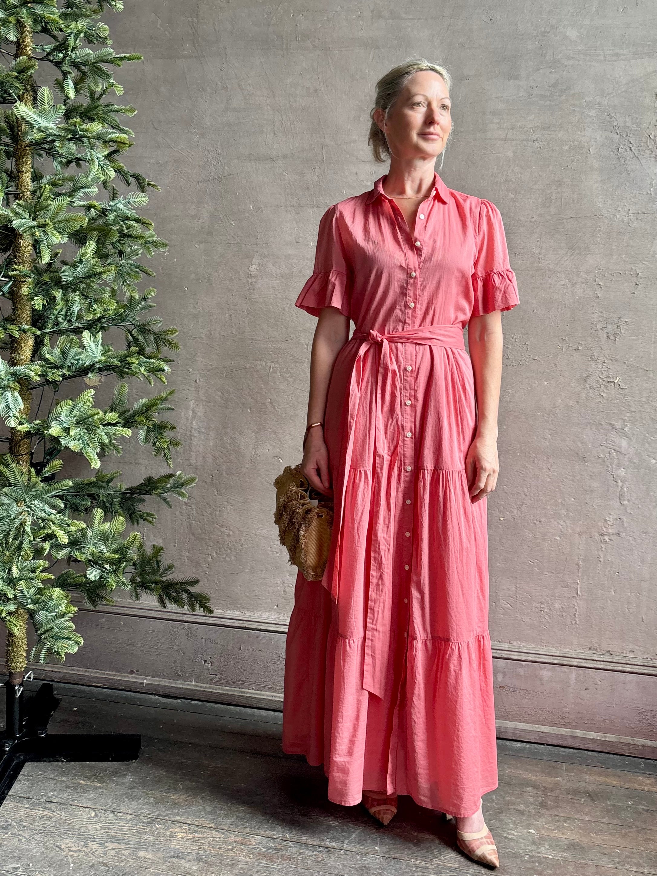 Image of woman wearing TROVATA Martine button down cotton shirt dress in Rosdo rose with feminine ruffle sleeves and tiered skirt