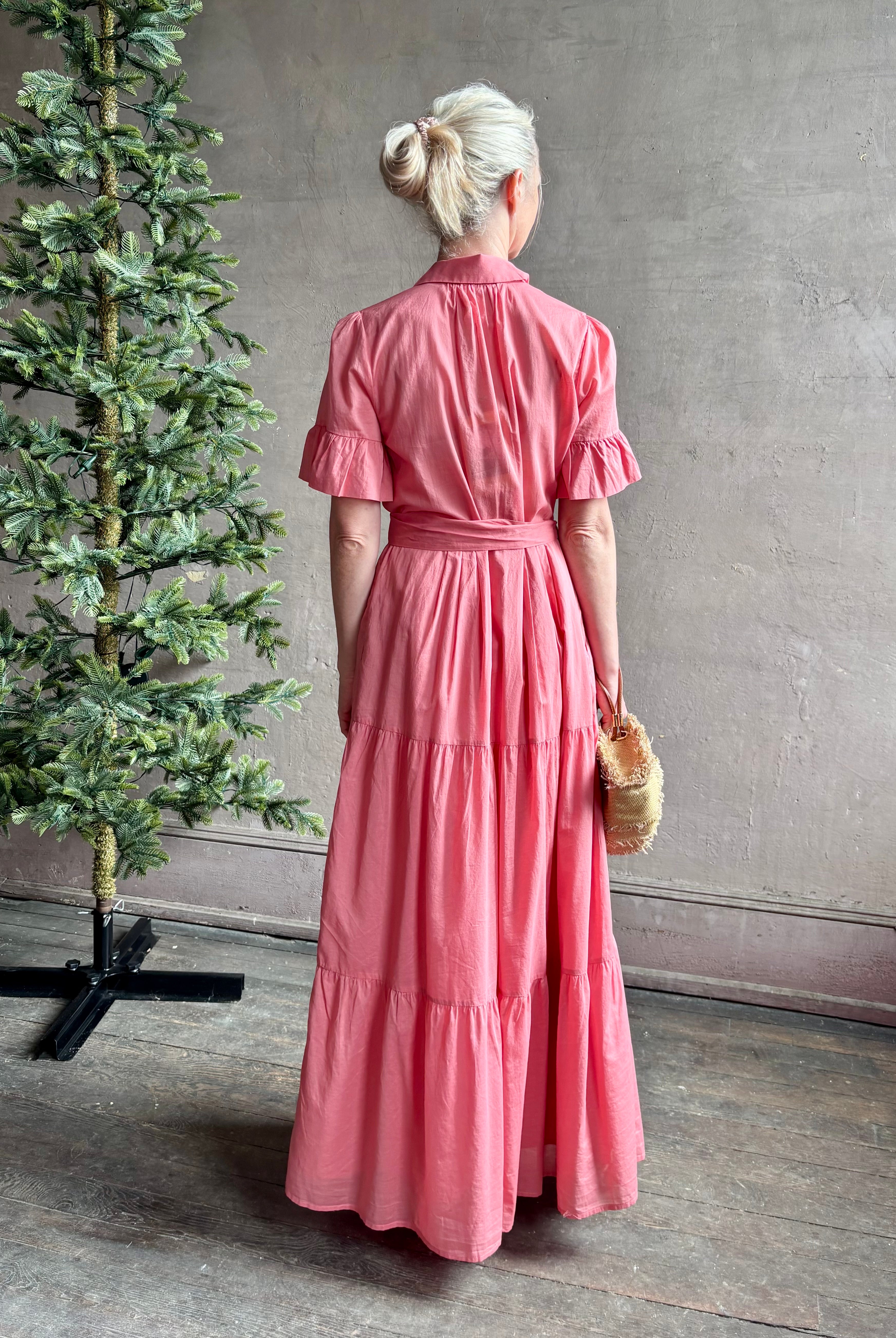 Image of woman wearing TROVATA Martine button down cotton shirt dress in Rosdo rose with feminine ruffle sleeves and tiered skirt