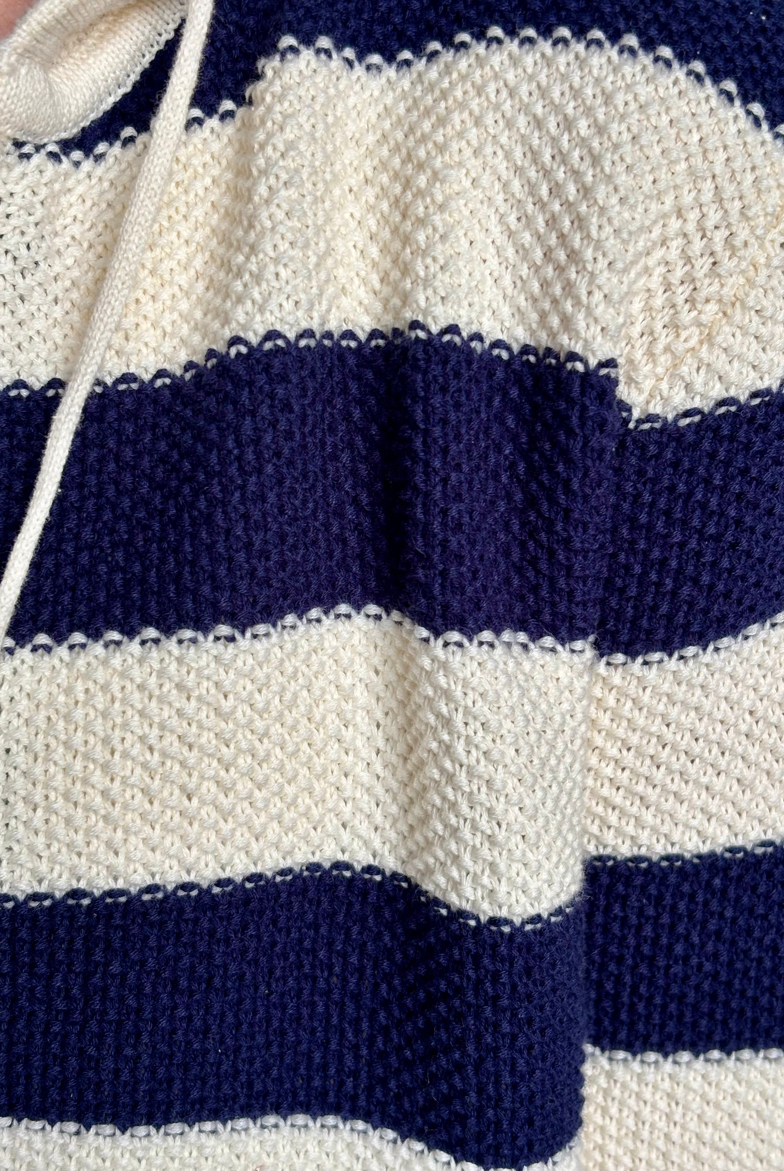 Mature woman wearing comfy cotton Rafa zip up hoodie by Trovata in a classic navy and white stripe with an elevated gold tone zipper.