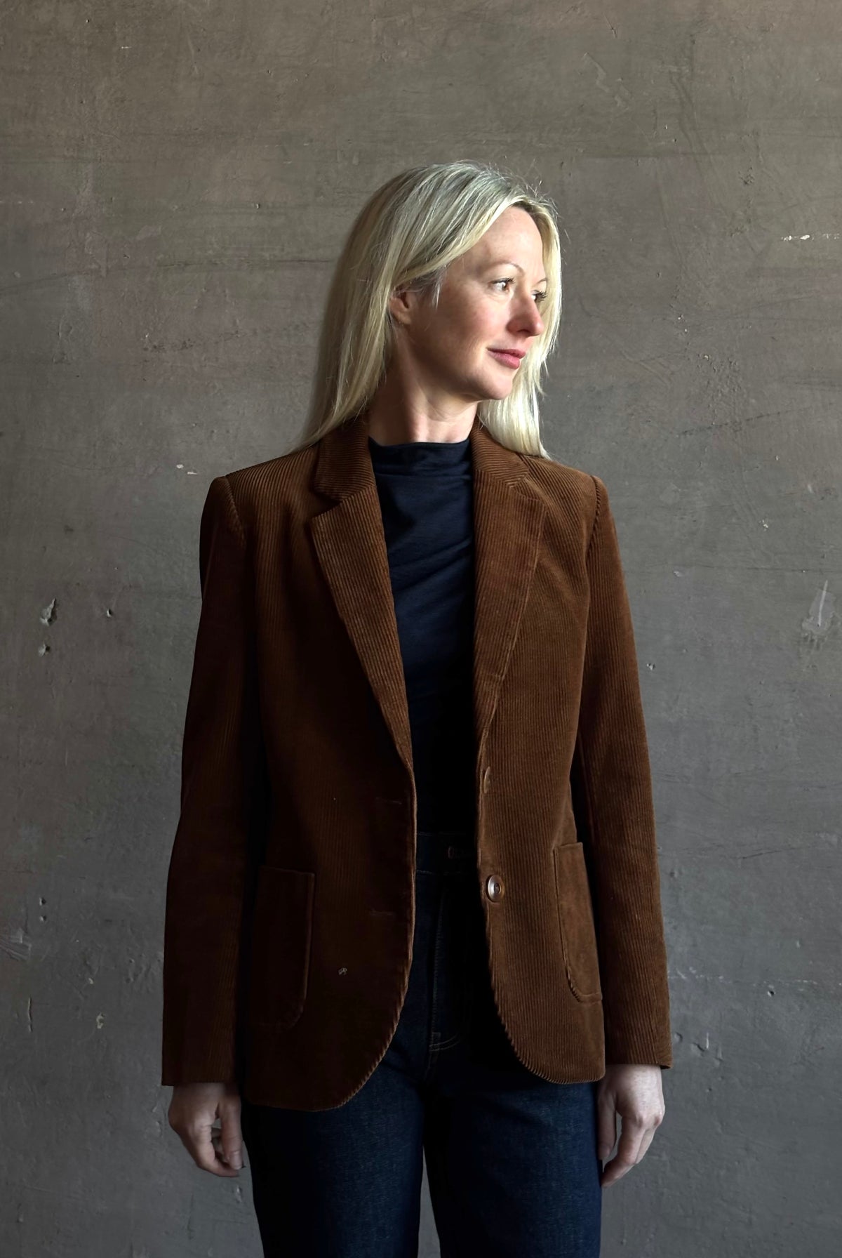 Mature woman wearing Trovata Skylar Cotton Corduroy Two Button Blazer in Walnut Brown front pockets heritage-inspired California tailoring