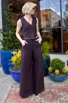 Image of model wearing luxury brand TWP Kikis Vest and Dees Trouser in premium chocolate linen for a matching set