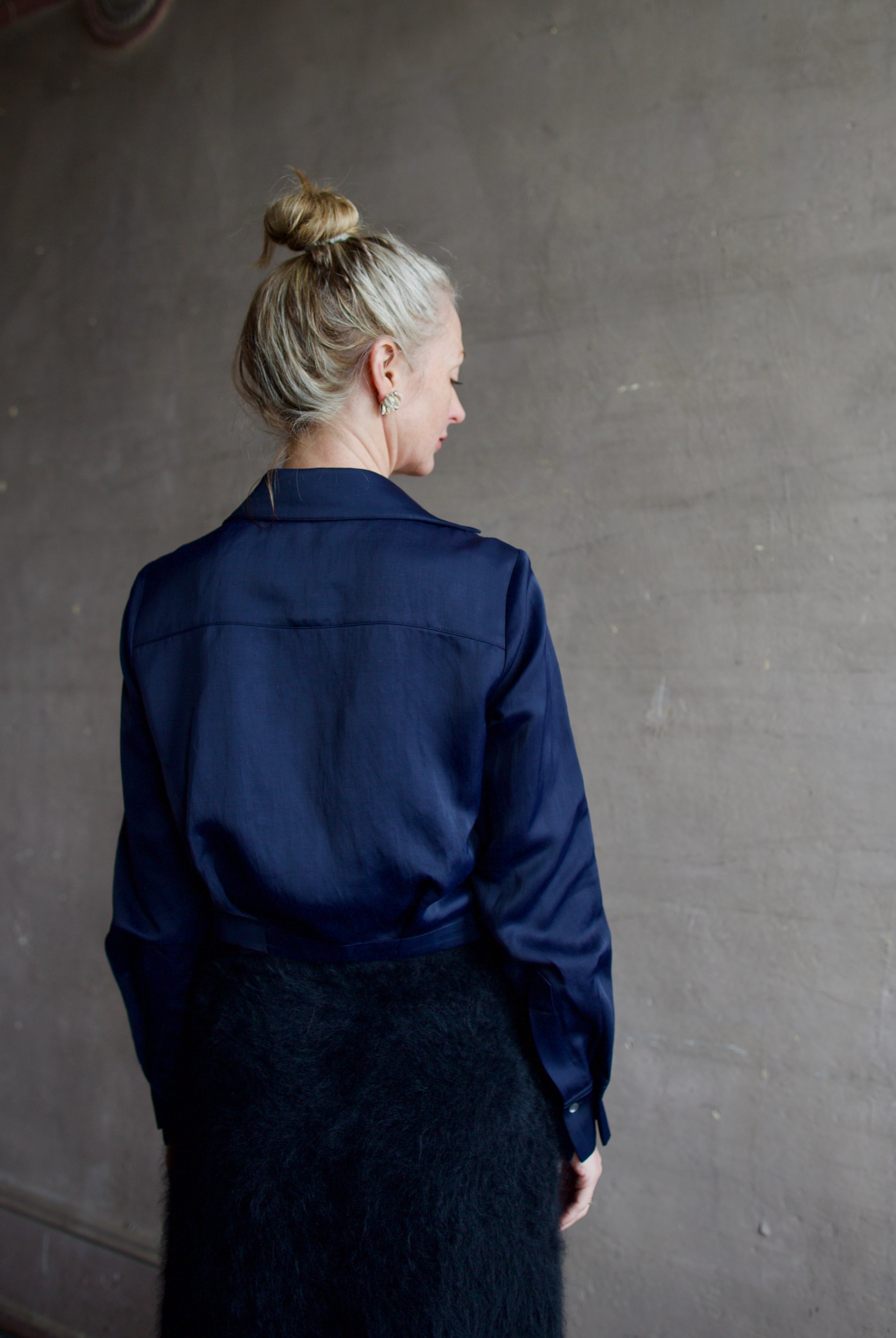 Mature woman wearing luxury women's viscose-linen TWP GT Goan navy blouse featuring cropped fit with wrap waistline and deep v-neckline