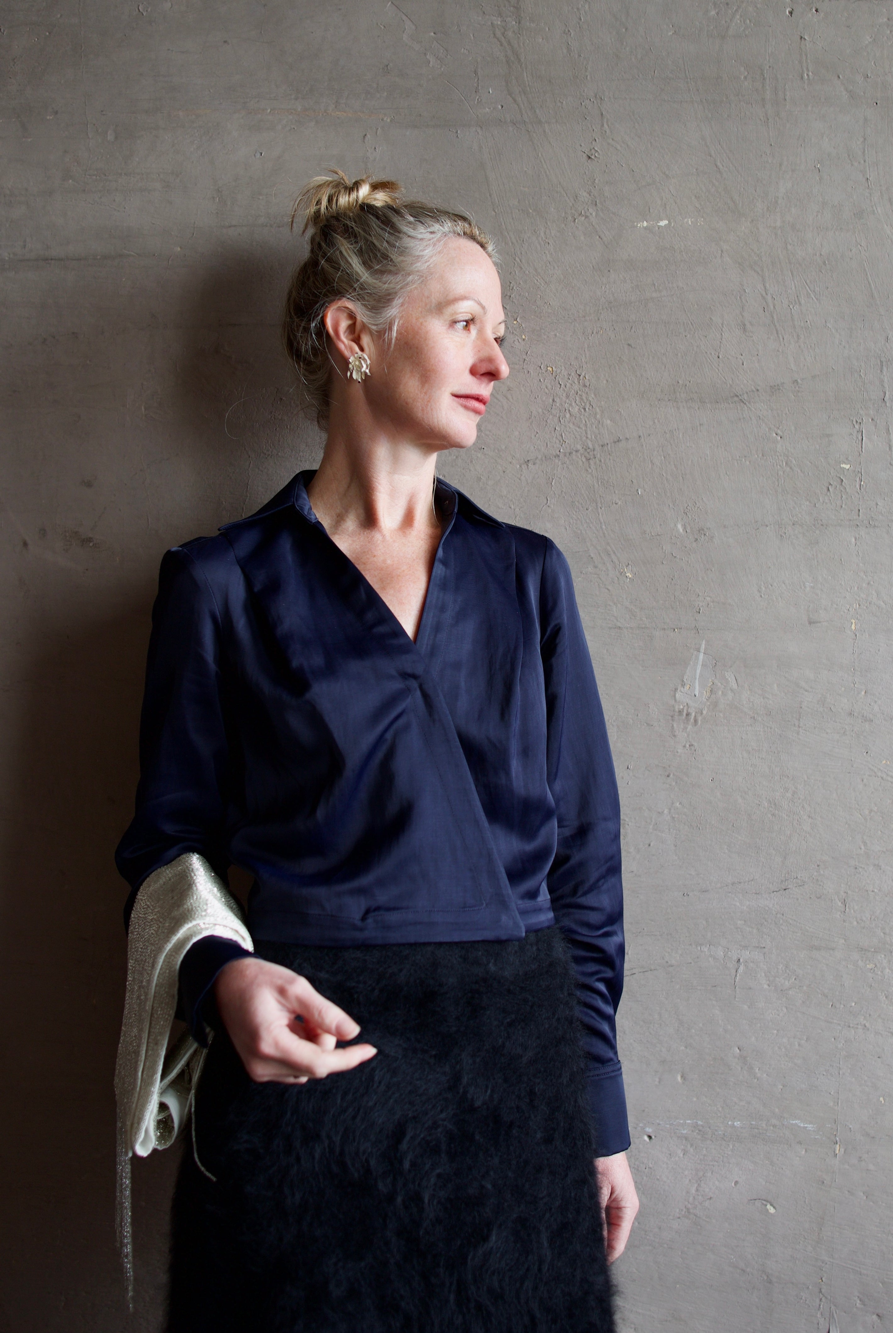 Mature woman wearing luxury women's viscose-linen TWP GT Goan navy blouse featuring cropped fit with wrap waistline and deep v-neckline