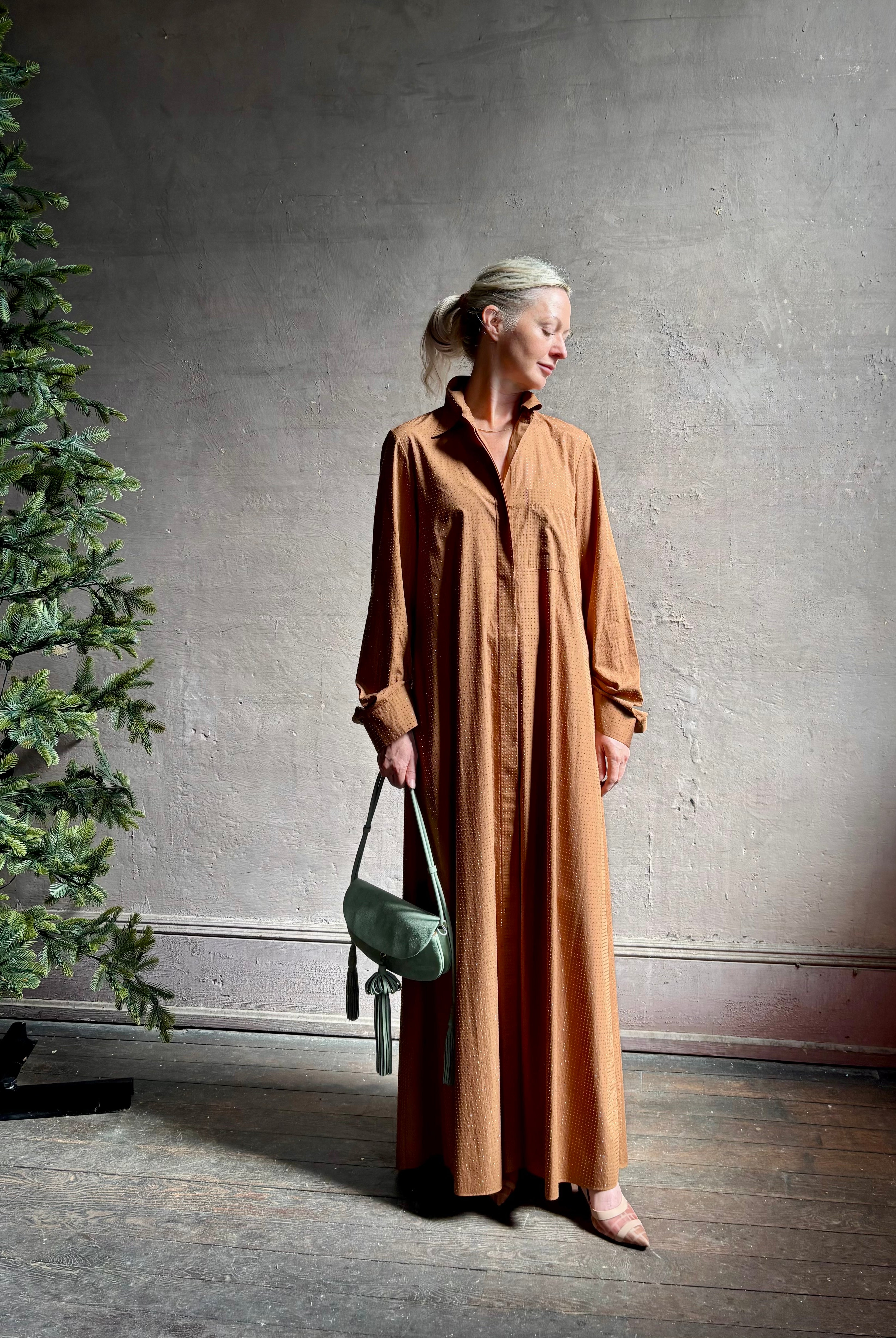 Mature woman wearing sophisticated TWP Jennys shirt dress embellished with crystals in warm brown