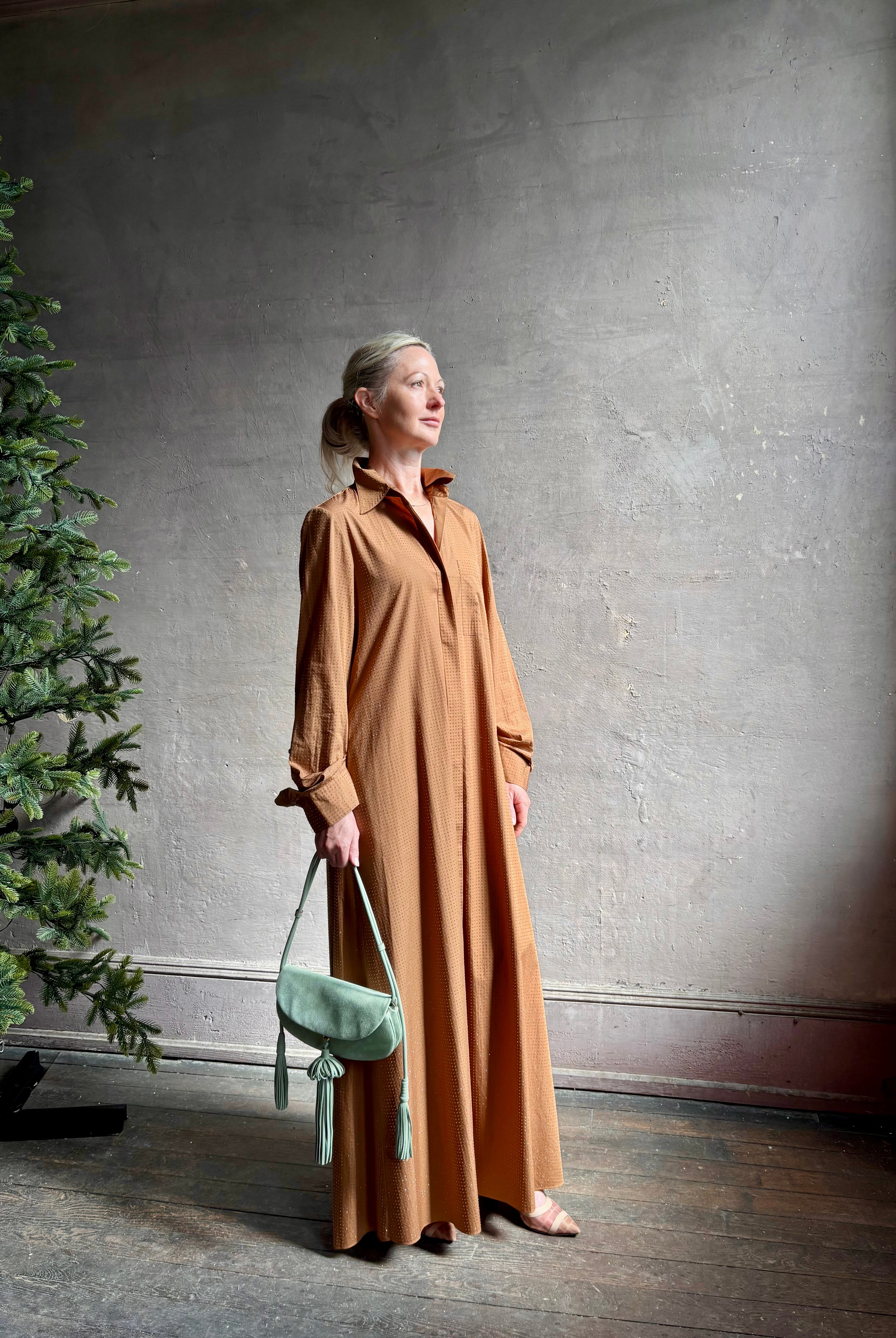 Mature woman wearing sophisticated TWP Jennys shirt dress embellished with crystals in warm brown