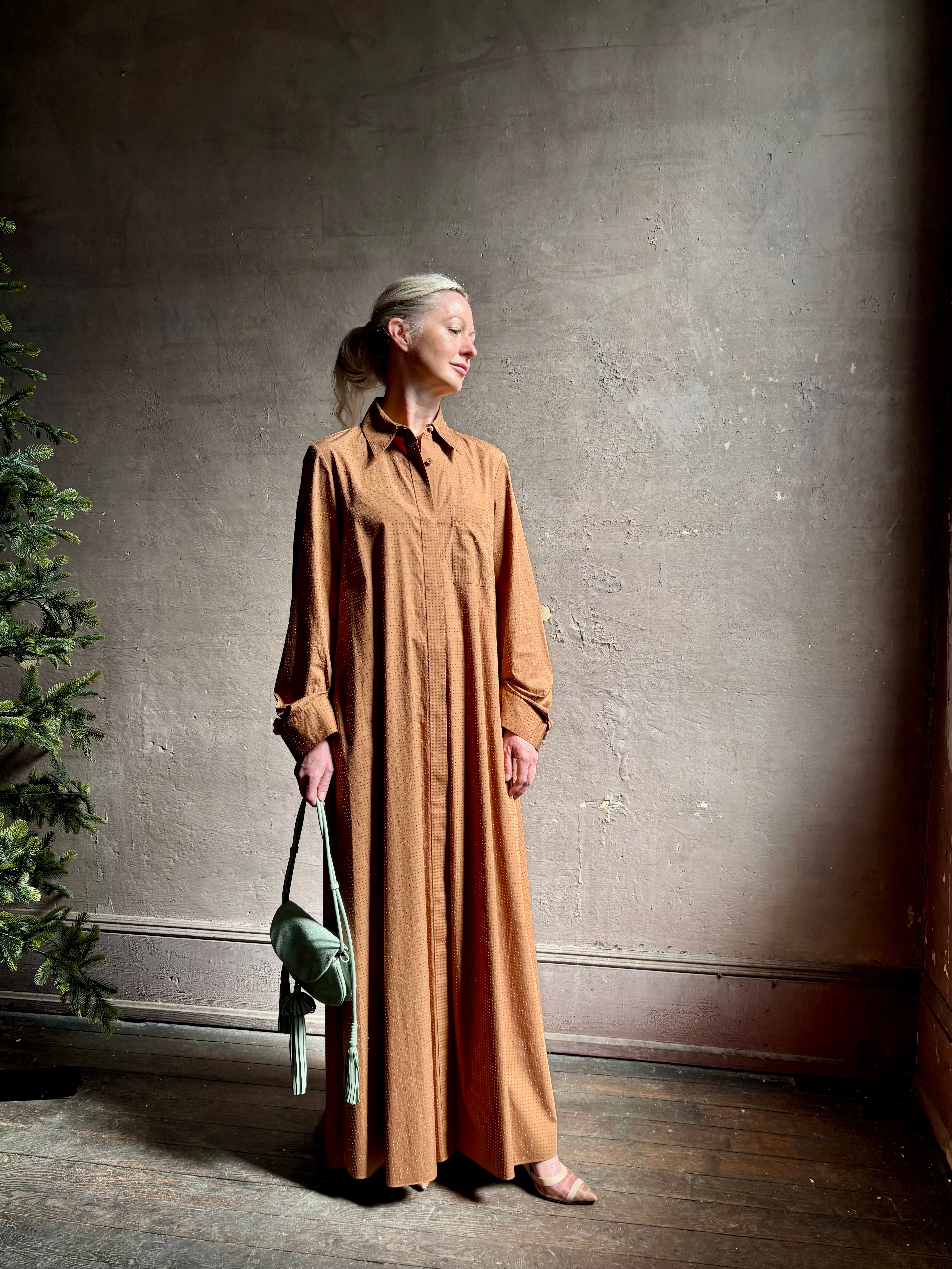 Mature woman wearing luxury TWP Jennys shirt dress embellished with crystals in warm brown