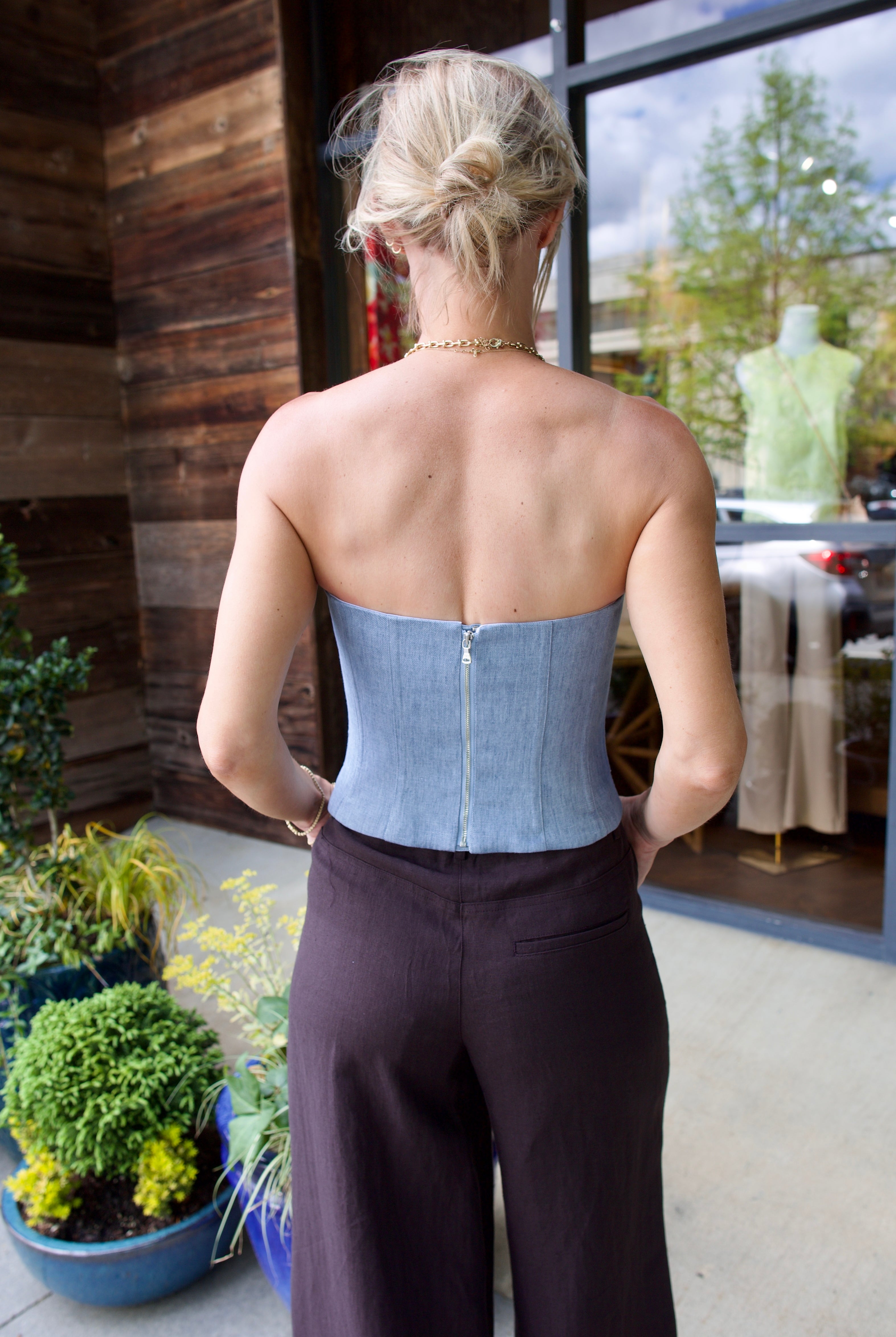 Model wearing women's luxury brand TWP Jillian Bustier in indigo hemp and chocolate Dee's Trousers with expert tailoring and elevated style