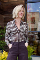 Image of model wearing luxury brand TWP Joey sheer top in premium cotton silk blend and fun chocolate and cream stripes