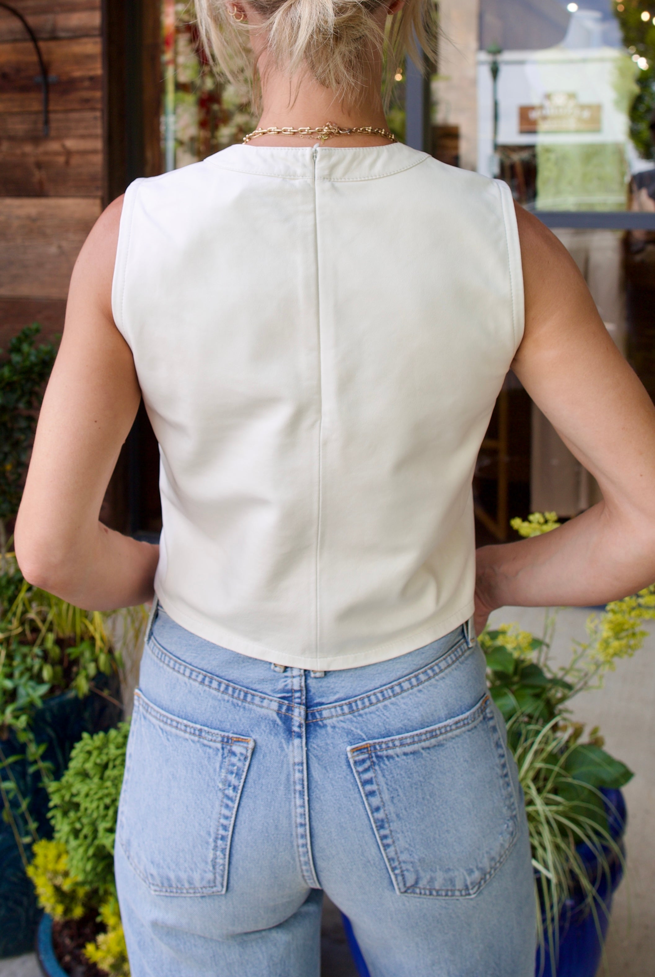 Woman wearing contemporary luxury fashion TWP lamb skin off white Leather Tank top elevated casual wear