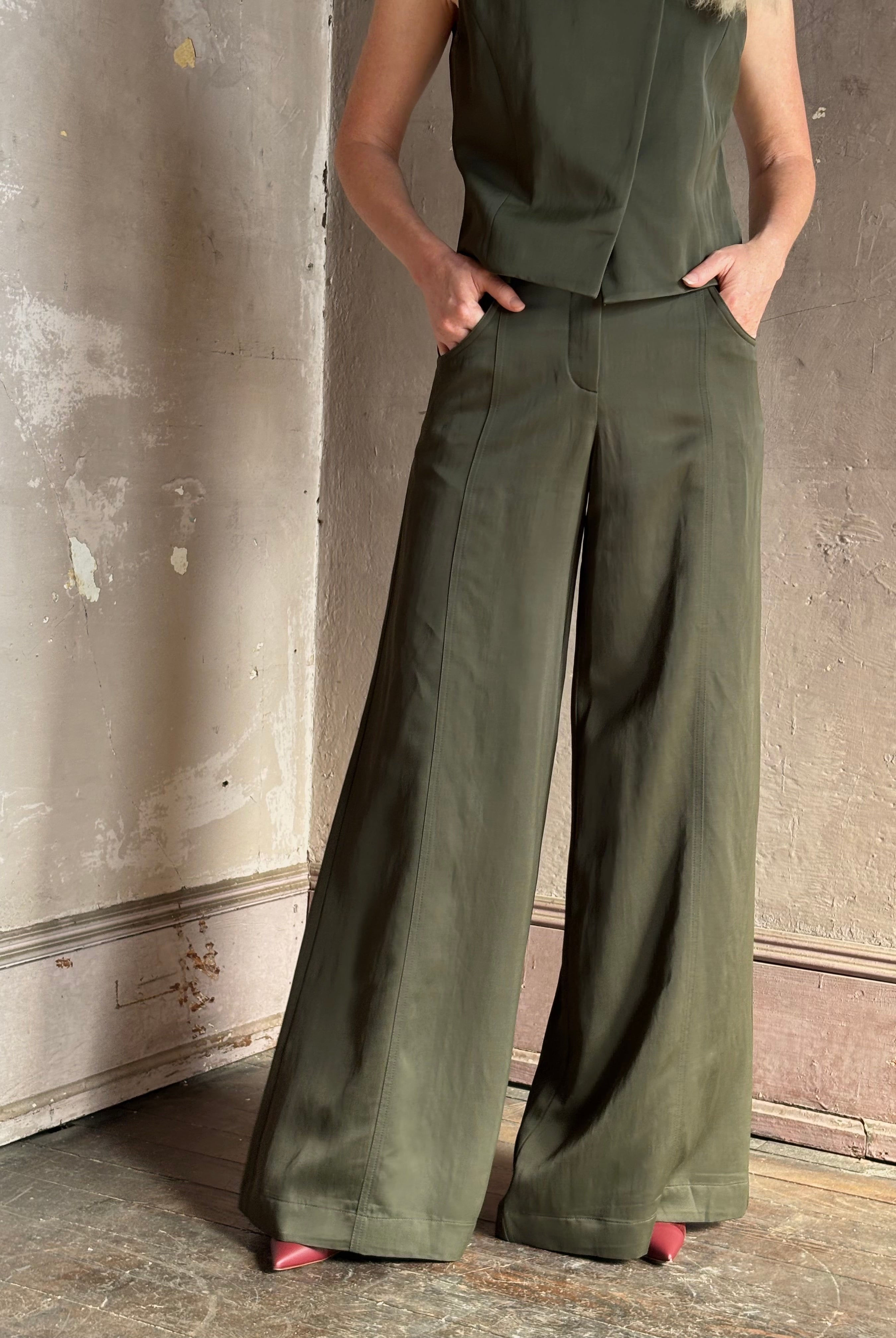 Mature woman wearing luxury women's clothing brand TWP Green Demie wide leg trouser linen viscose blend fabric
