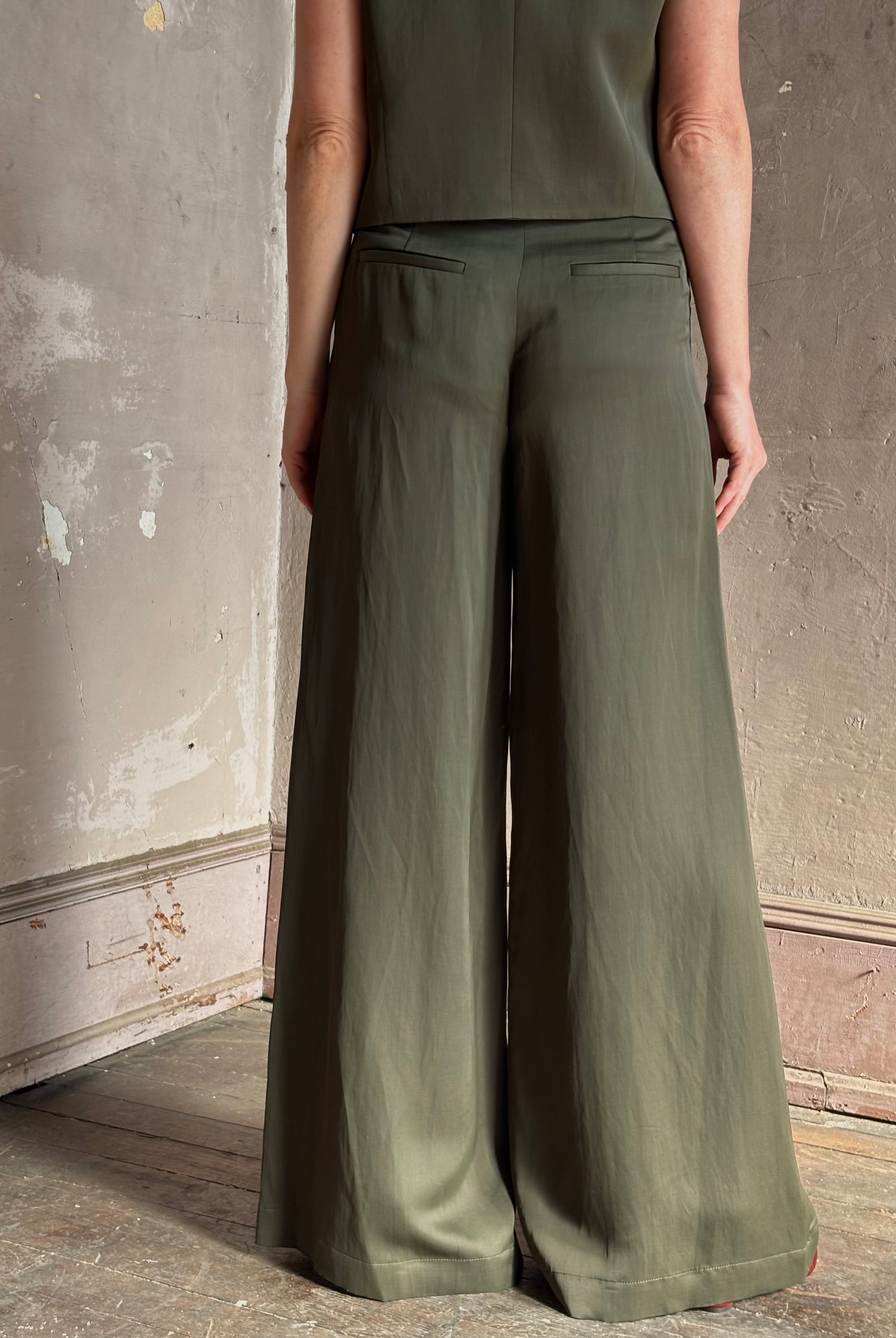 Mature woman wearing luxury women's clothing brand TWP Green Demie wide leg trouser linen viscose blend fabric